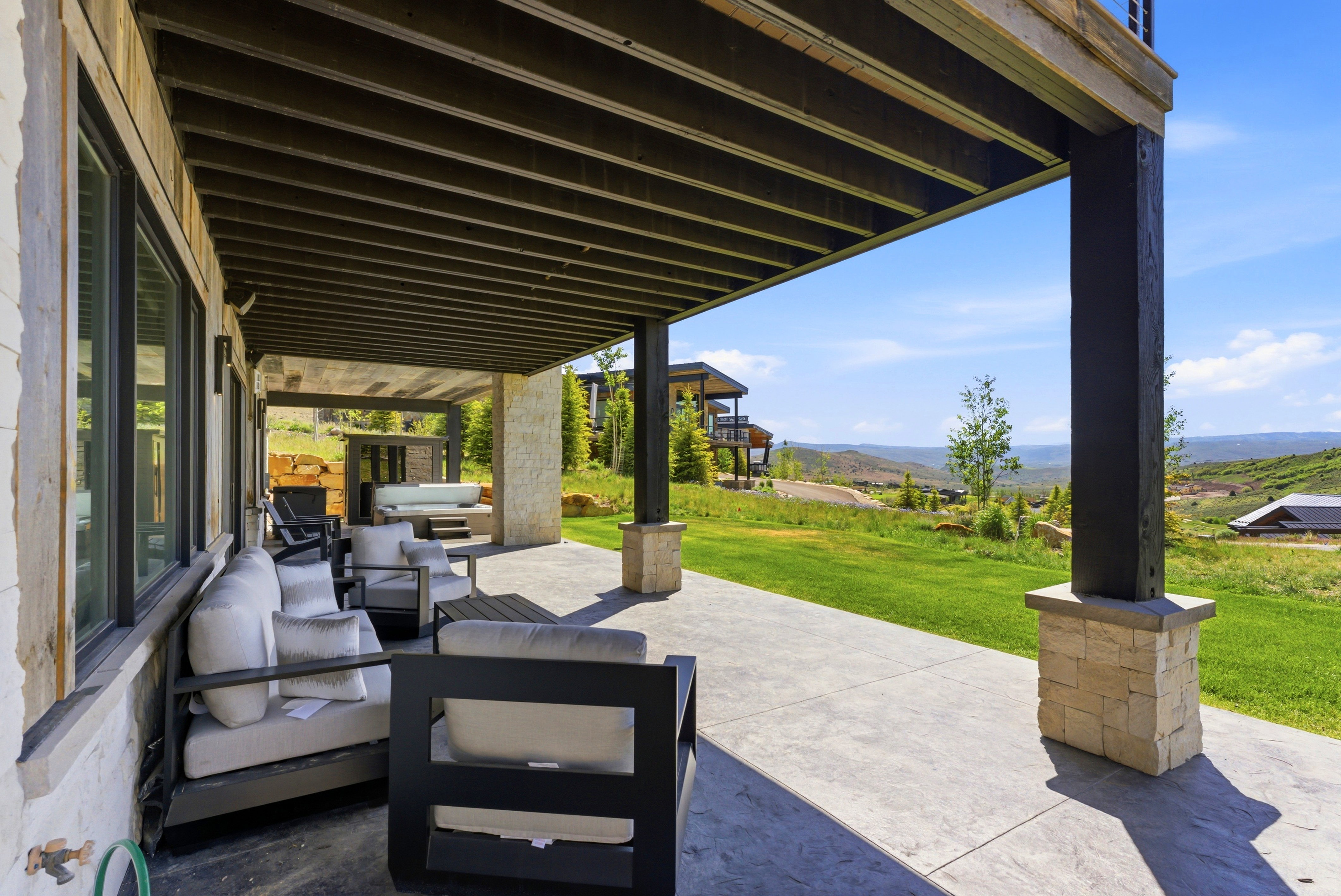 Covered patio with a concrete surface and substantial support columns