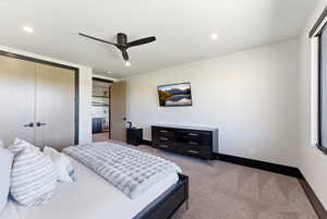 Spacious room featuring light-colored walls and carpet flooring