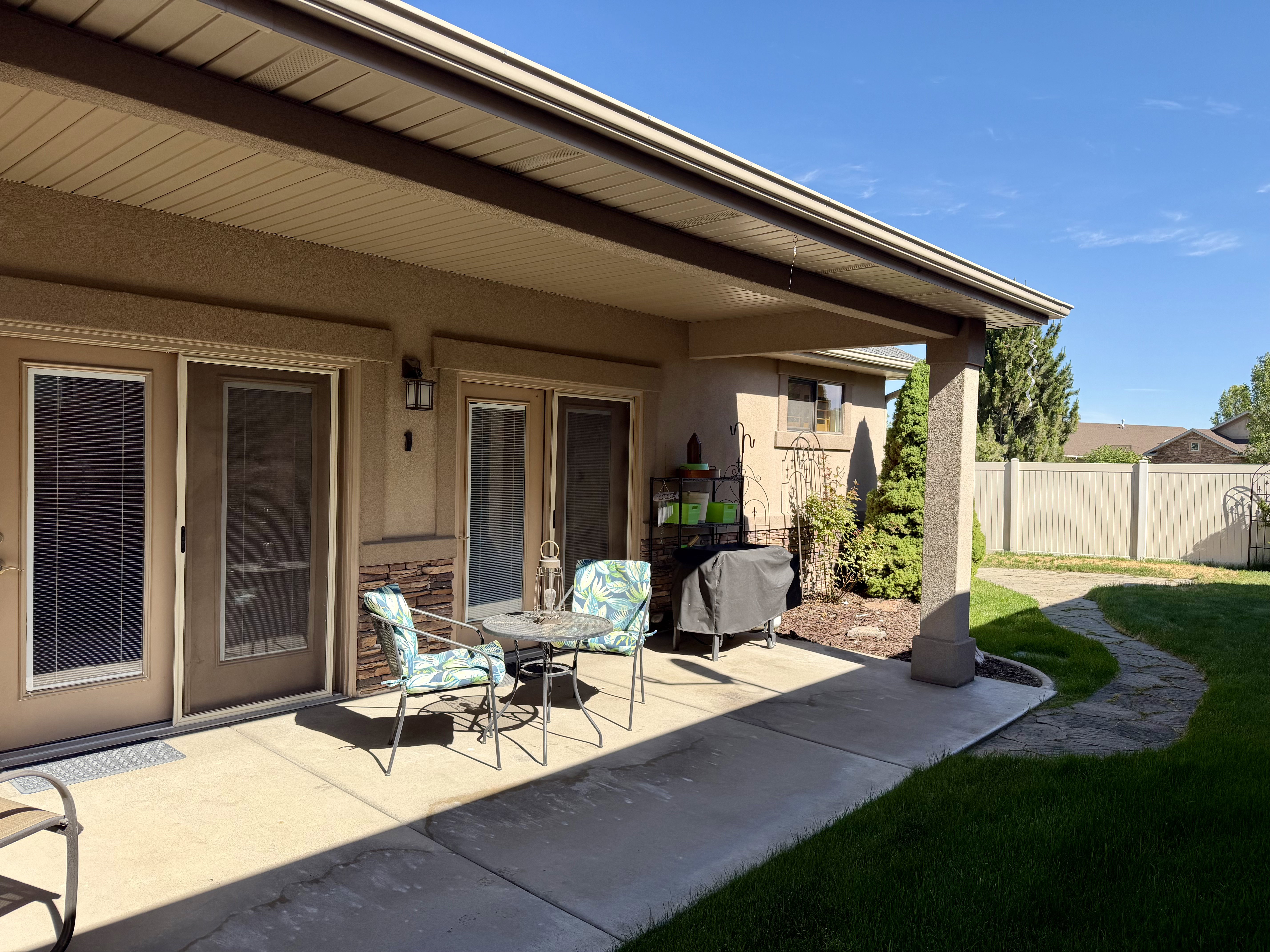 Covered patio is ideal for outdoor dining and relaxing with attractive architectural details and seamless access to the home