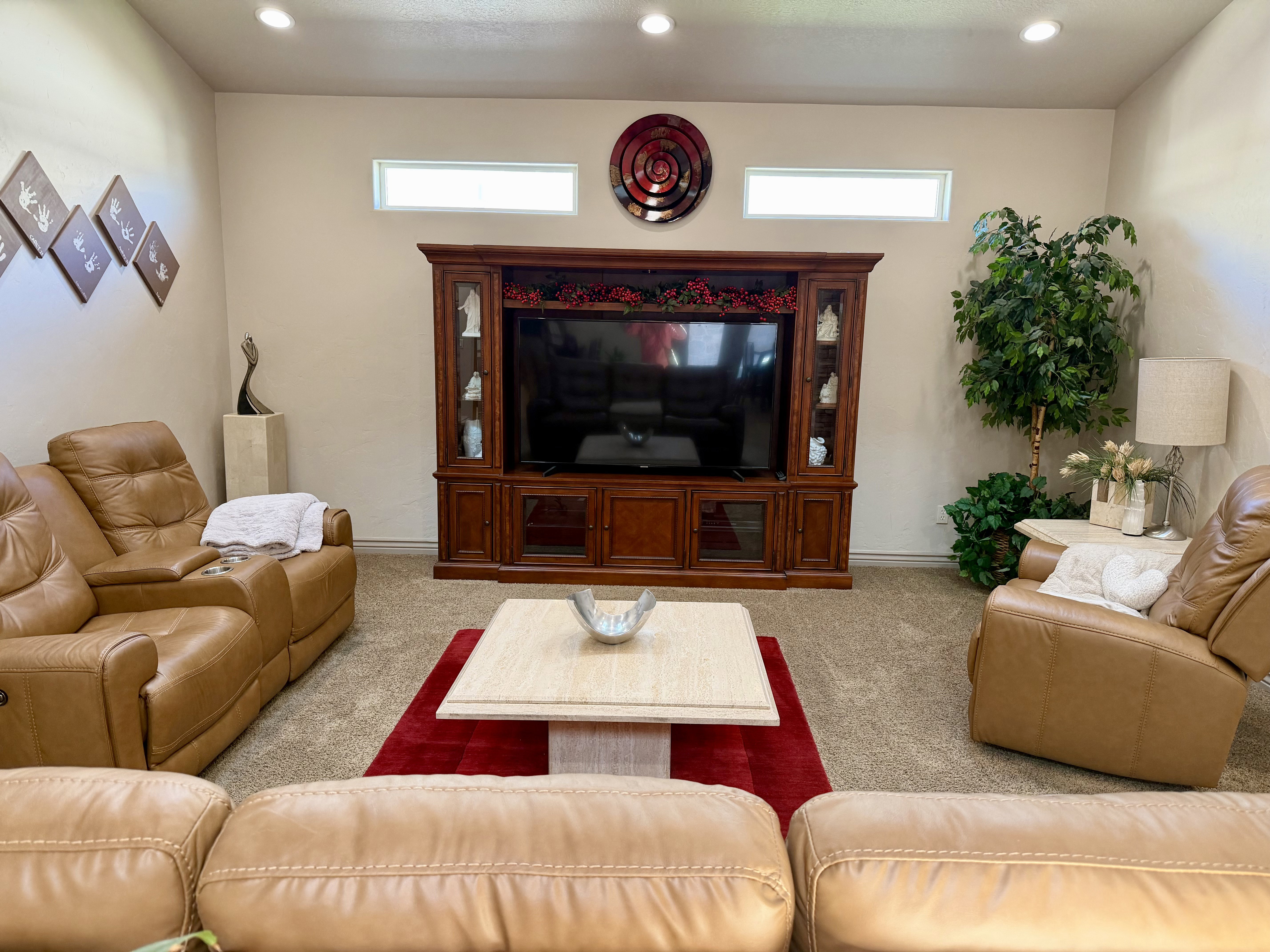 Living area featuring recessed lighting, high ceilings, carpeted flooring, and transom windows