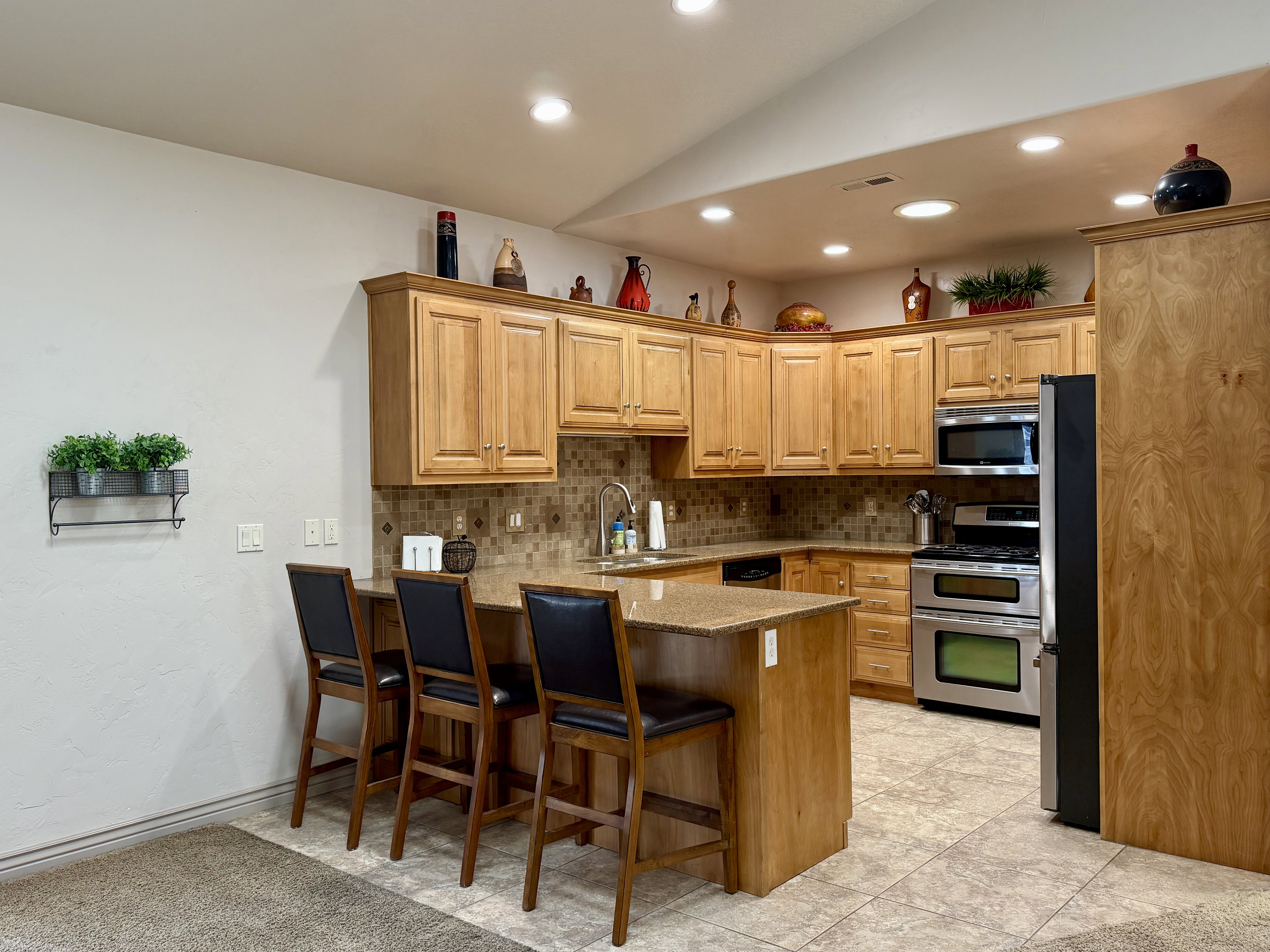Large breakfast bar offers generous seating and crates the perfect gathering space for entertaining or everyday living.