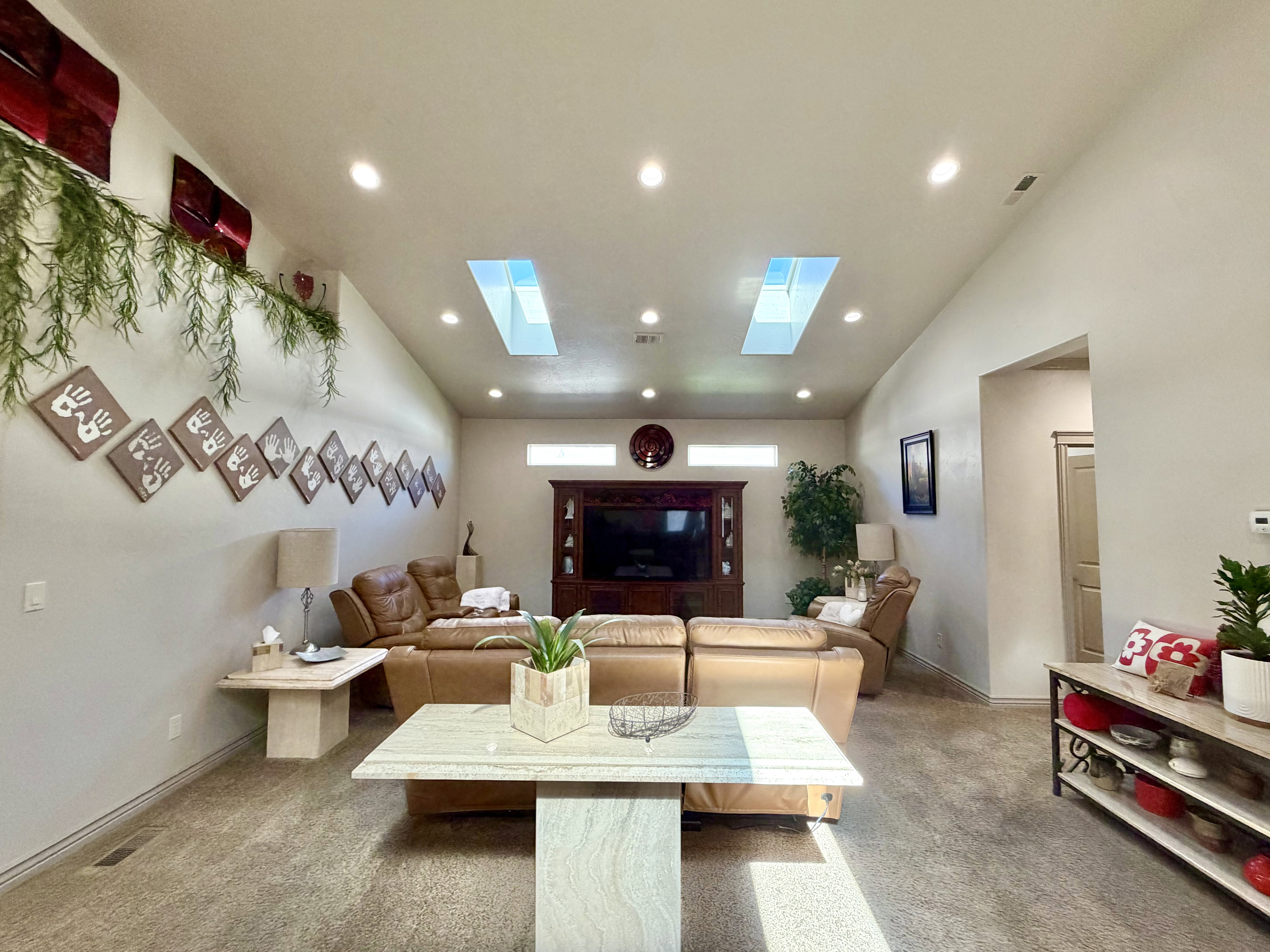 Vaulted ceiling family room featuring two skylights providing abundant natural light, this large room provides plenty of room