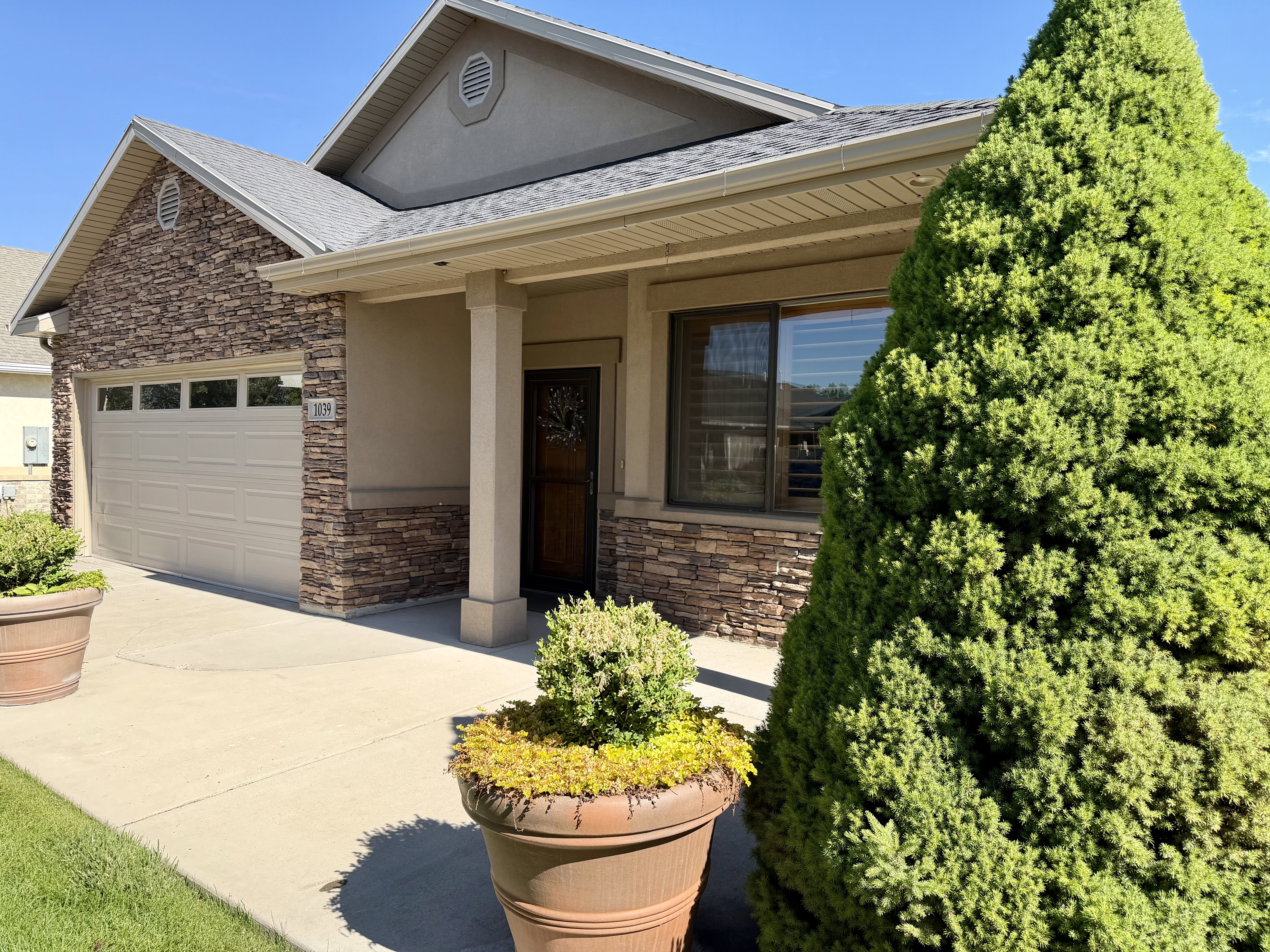 Stunning stonework, lush landscaping, and beautiful mature trees in a quiet, desirable neighborhood.