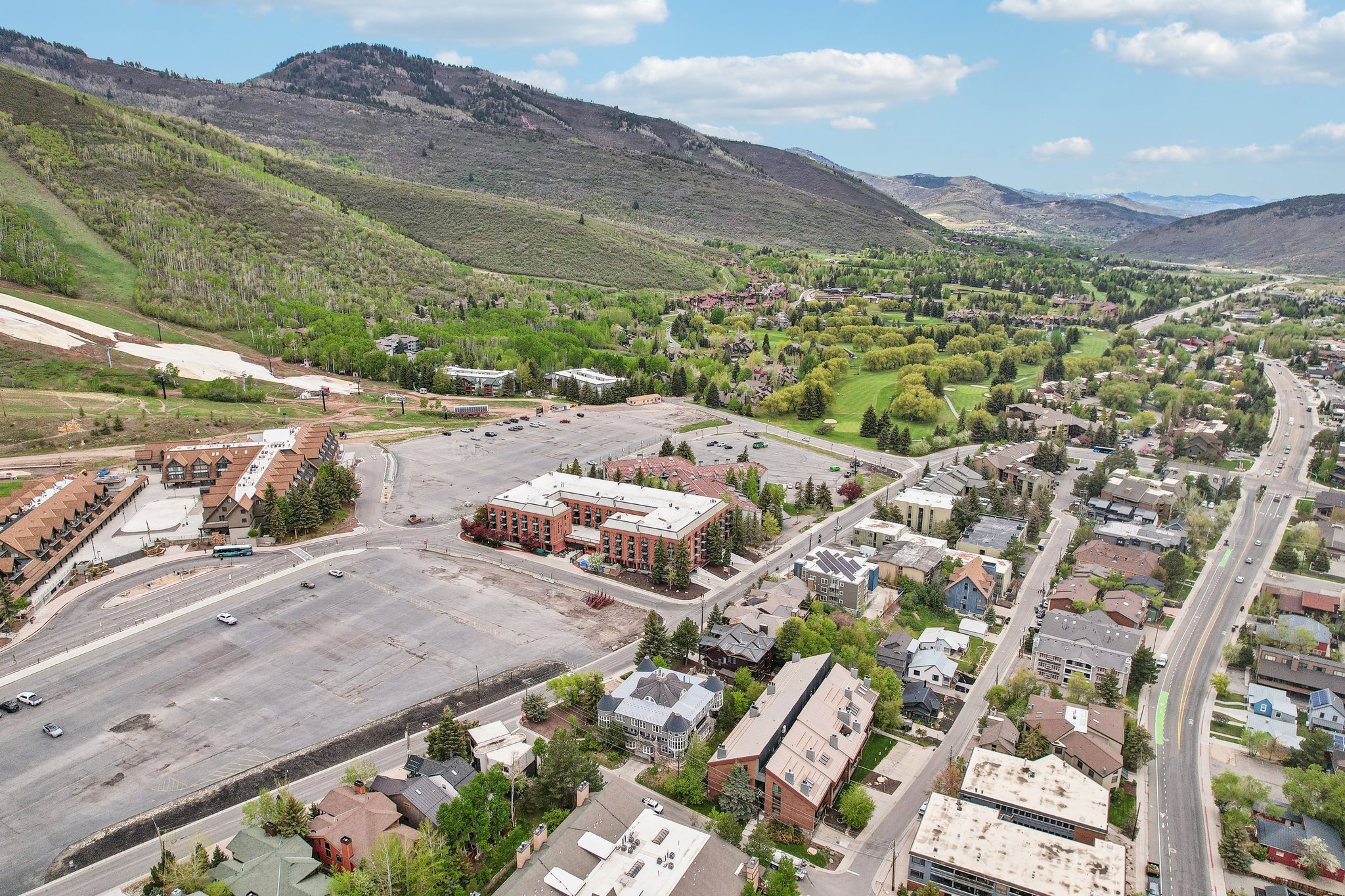 Aerial perspective showcasing a vibrant community nestled among verdant mountains