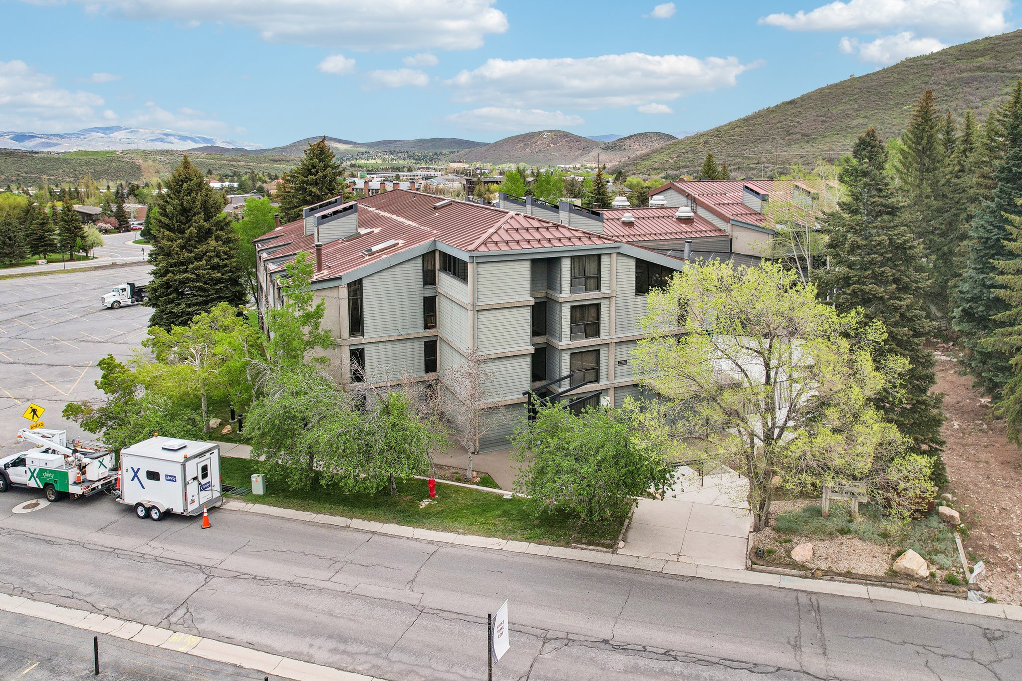 Multi-story building featuring a tile roof and multiple window units