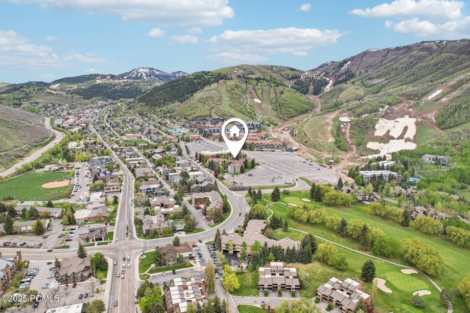 Aerial perspective showcasing mountainous terrain, a developed urban area, and extensive green spaces