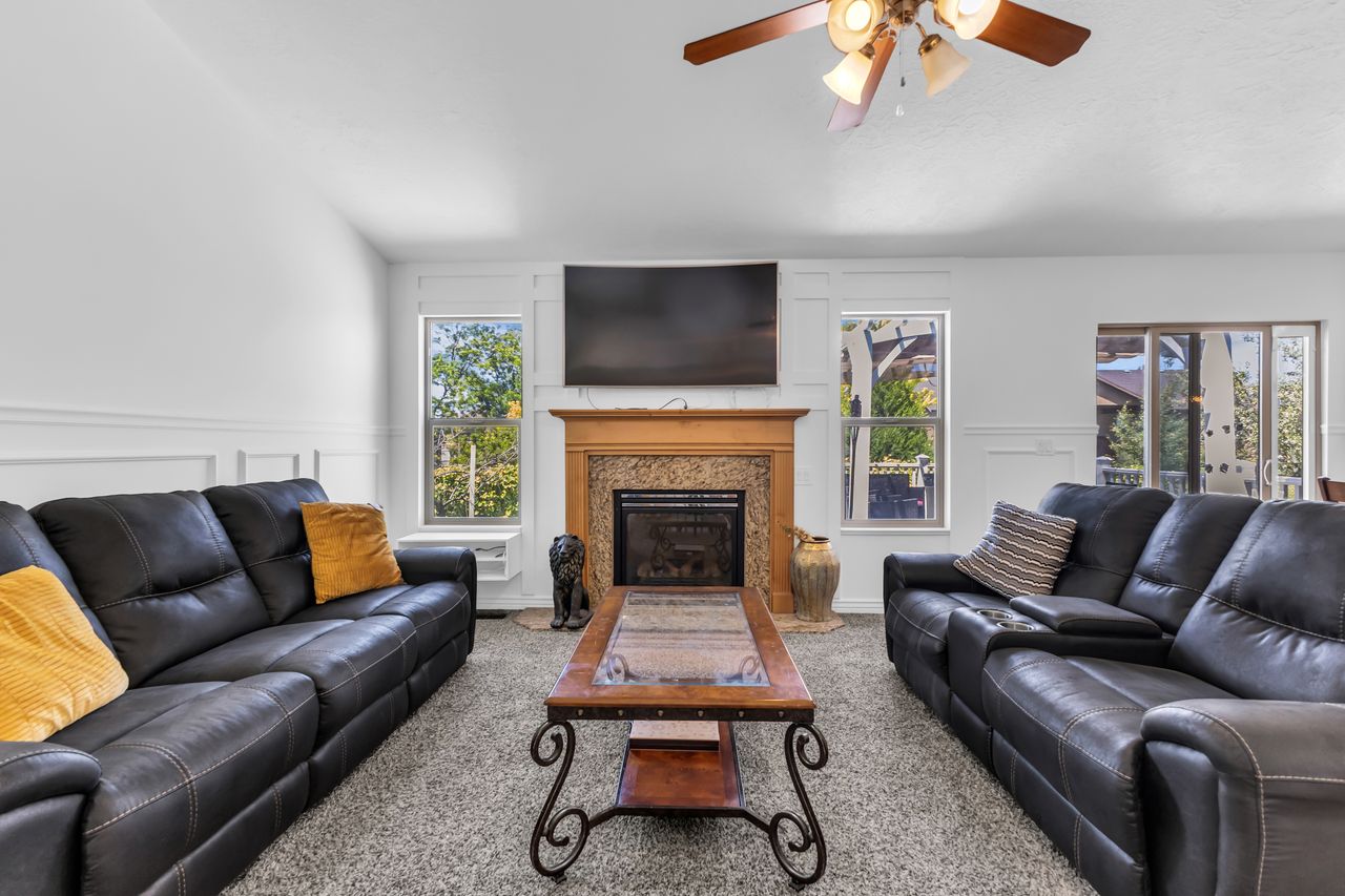 Living area featuring a central fireplace with a wood mantel and stone surround