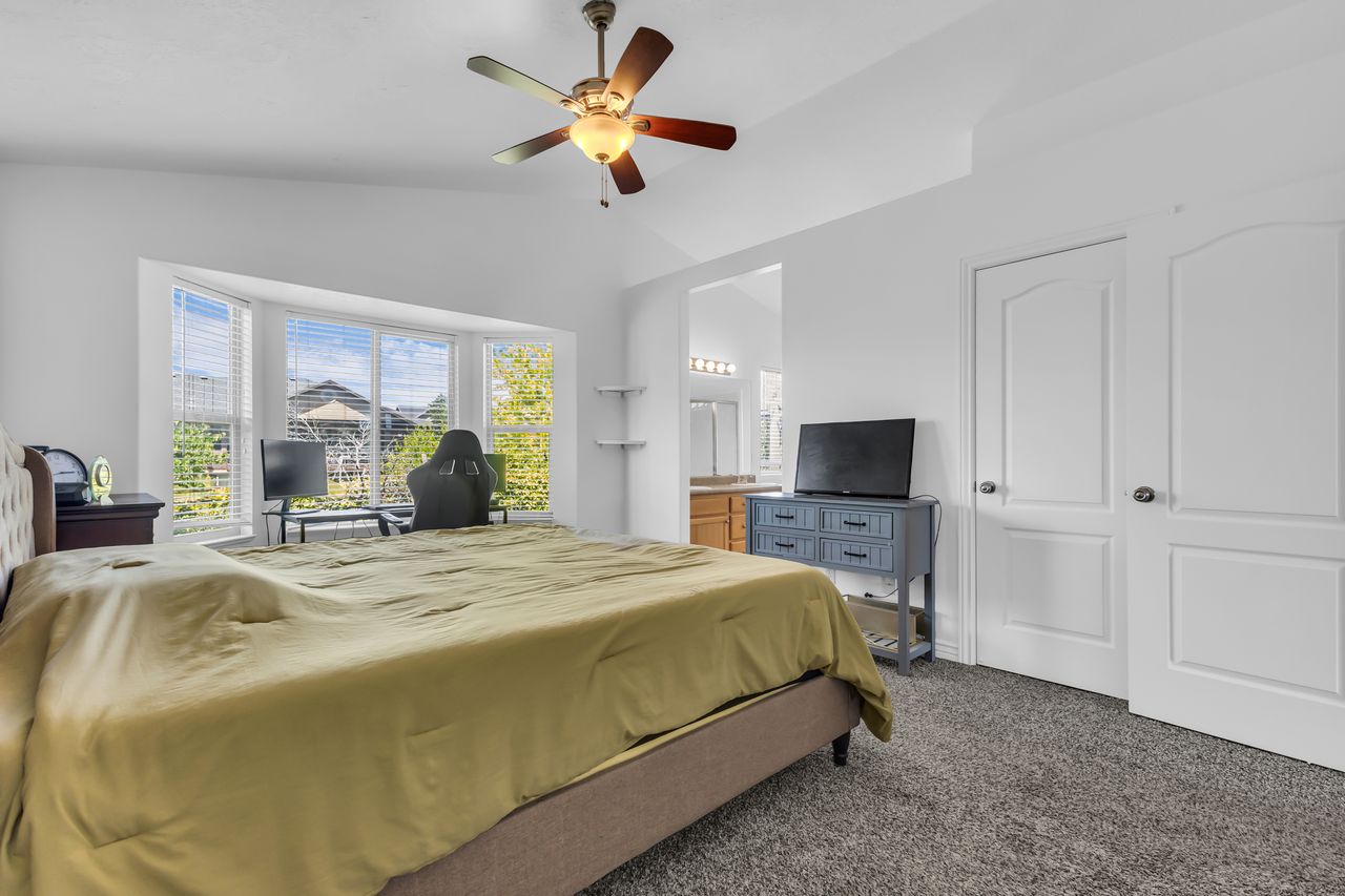 Vaulted ceilings featuring a ceiling fan with integrated lighting