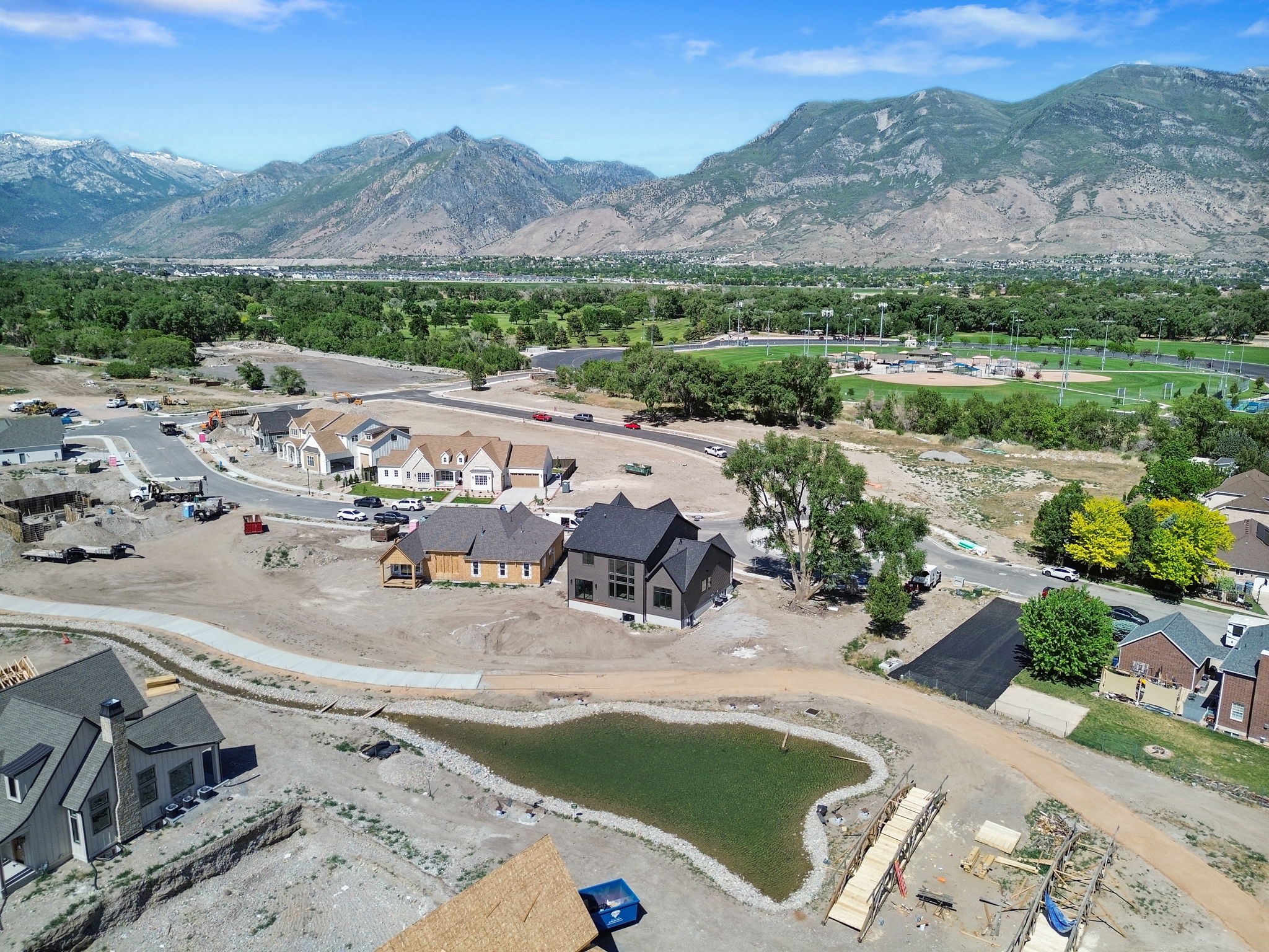 New construction residences featuring varied architectural styles and mountain backdrops