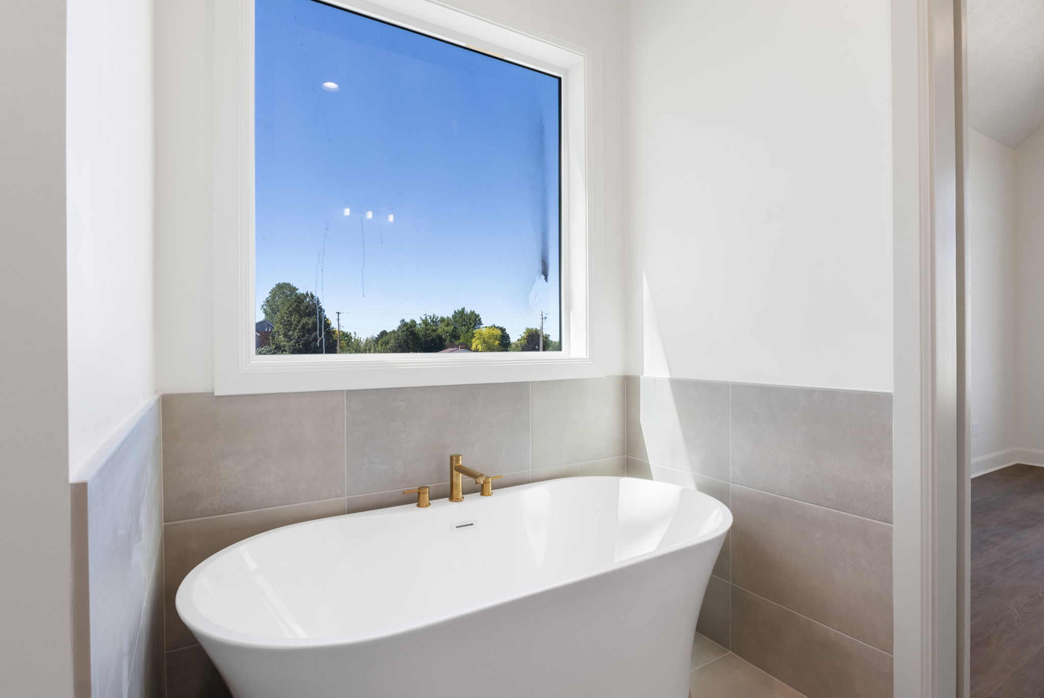 Freestanding soaking tub with gold-finish fixtures