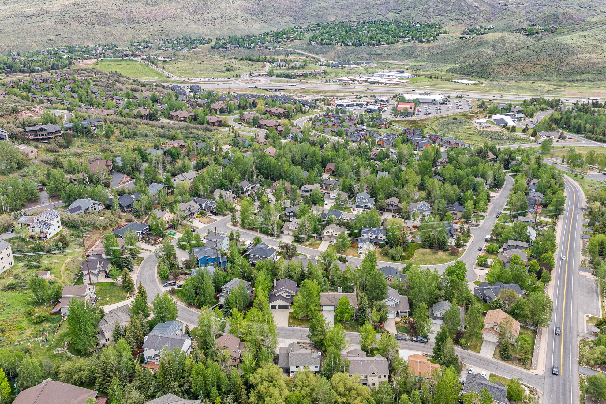 Residential neighborhood featuring winding roads and mature trees