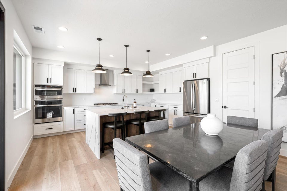 Open-concept kitchen and dining area featuring light wood-finish flooring