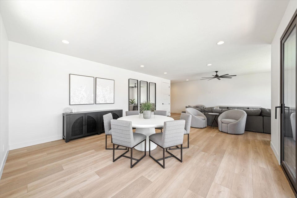 Bright, open-concept living space featuring wood-finish flooring and recessed lighting