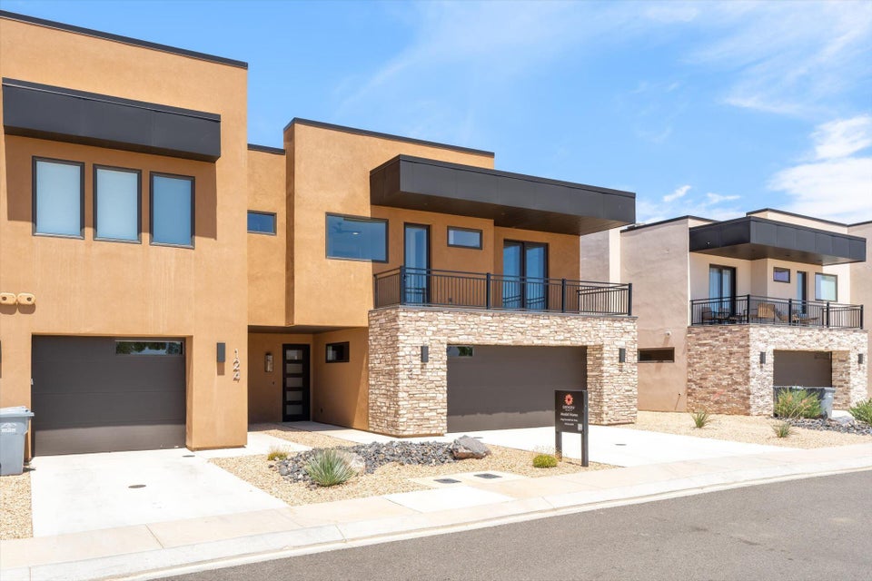 Contemporary multi-level exterior with stucco finish and stacked stone accents