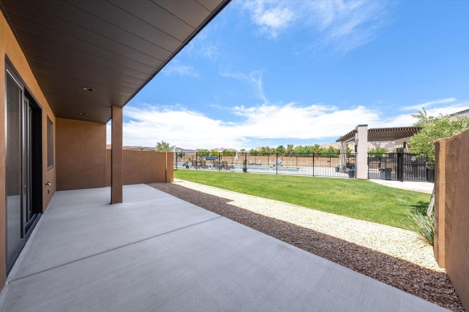 Expansive covered patio featuring a concrete slab, recessed lighting, and direct access to a manicured lawn