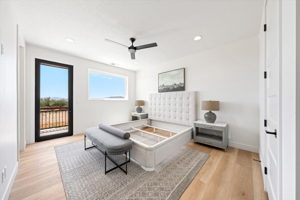 Light wood-finish flooring complements the bright white walls and recessed lighting