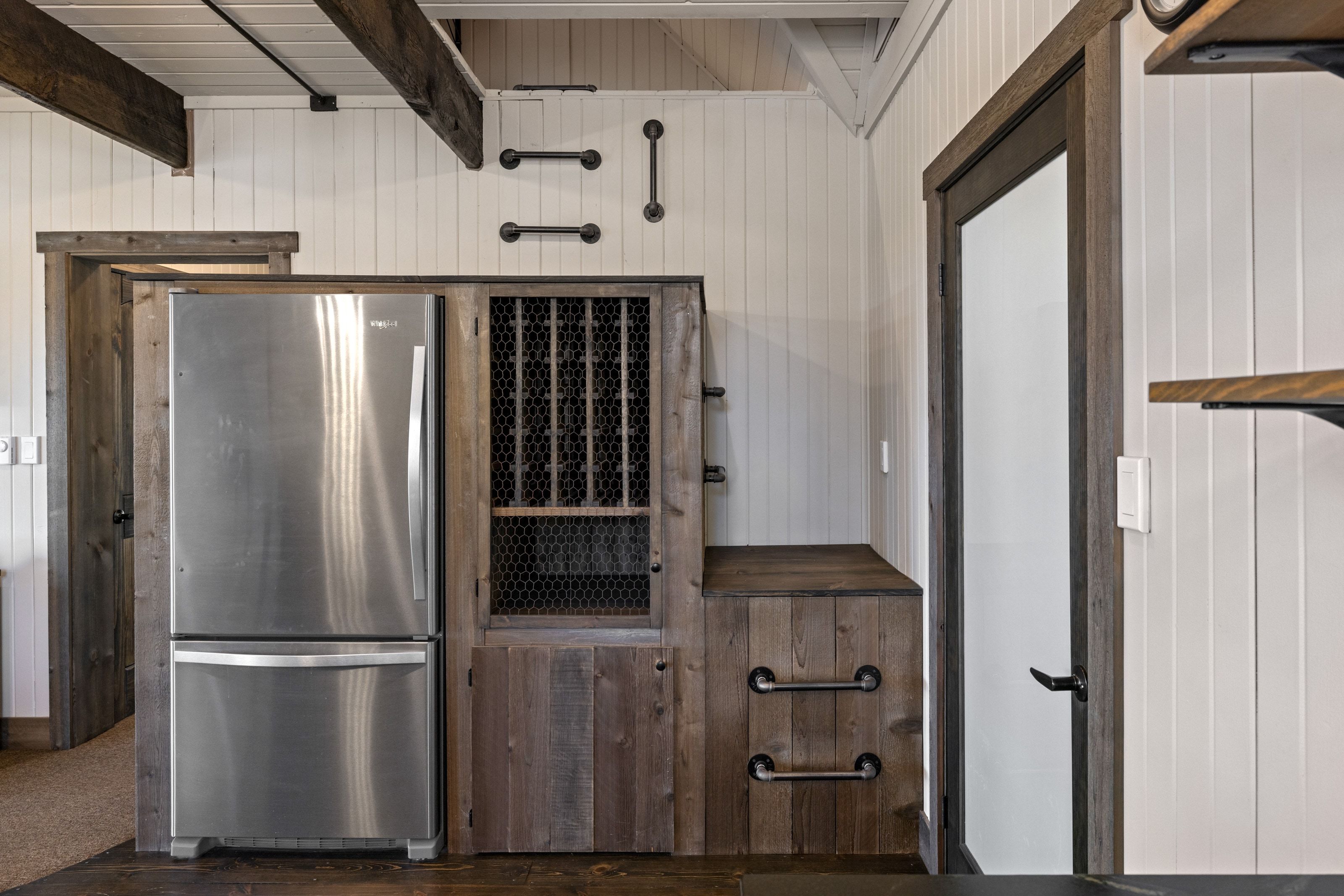 Kitchen with freestanding refrigerator and beam ceiling