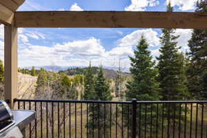 Balcony featuring a forest view