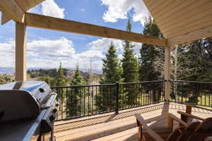 Wooden deck featuring area for grilling