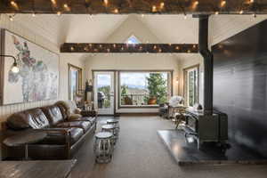 Carpeted living area with a wood stove