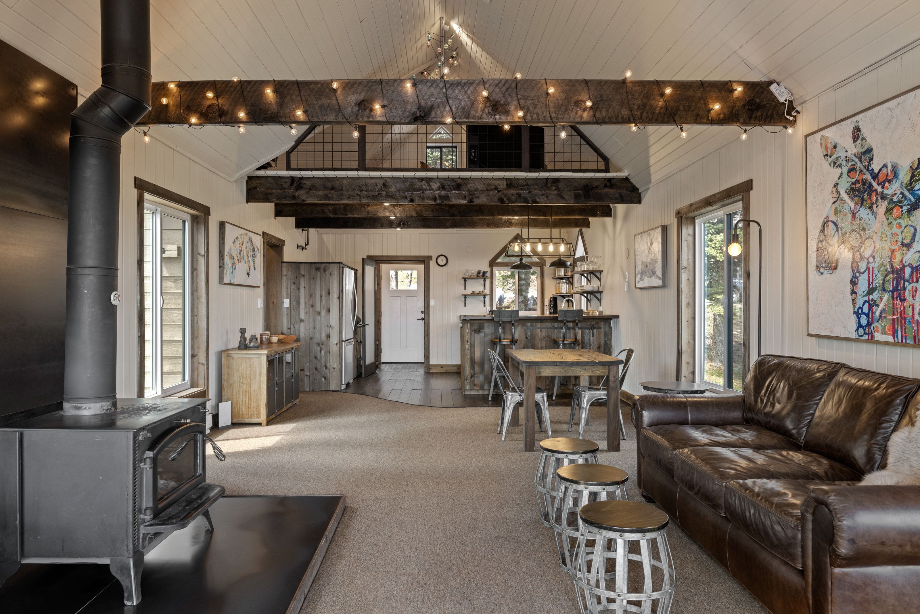 Living area featuring a wood stove and carpet flooring