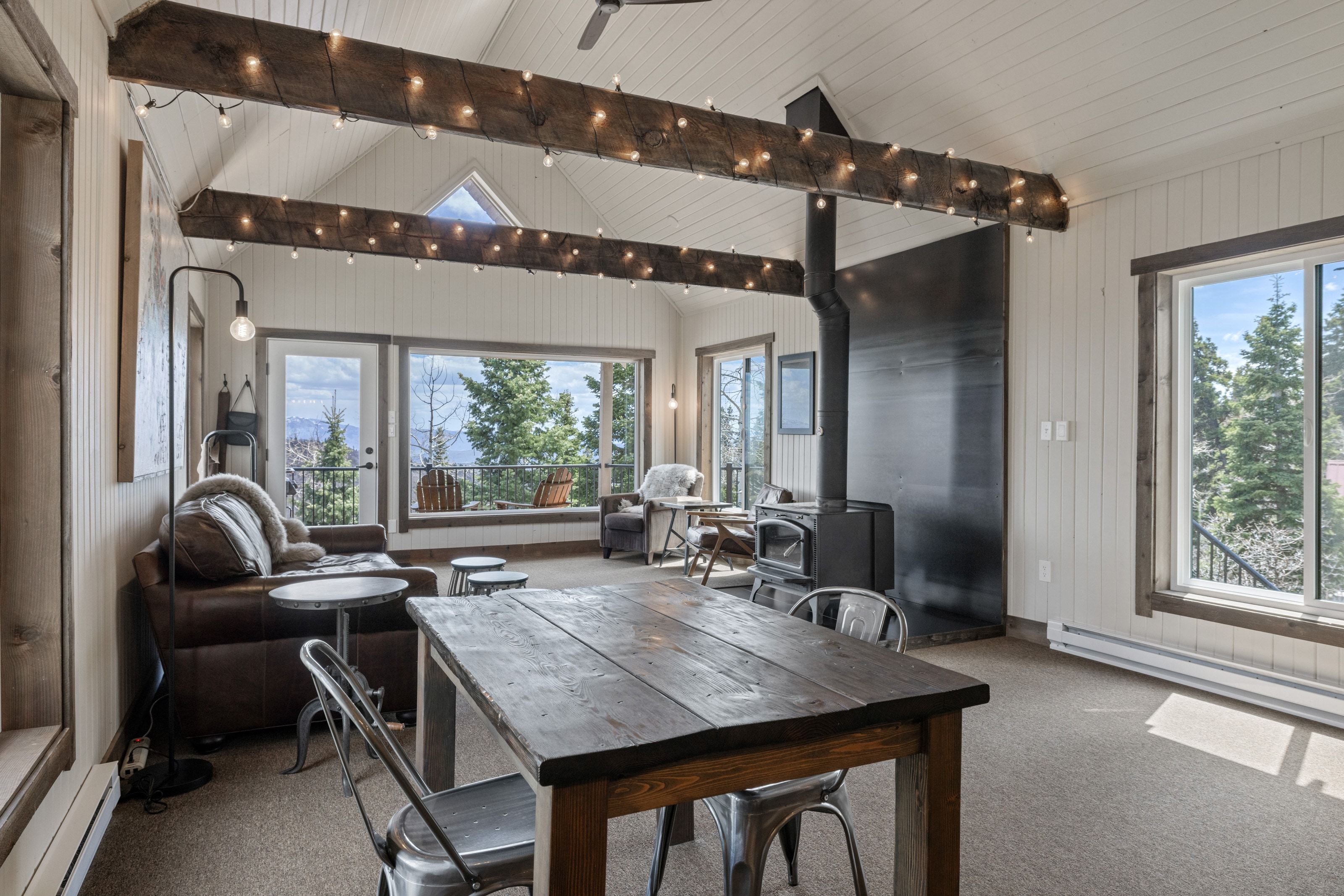Dining space with a wood stove, healthy amount of natural light, and baseboard heating