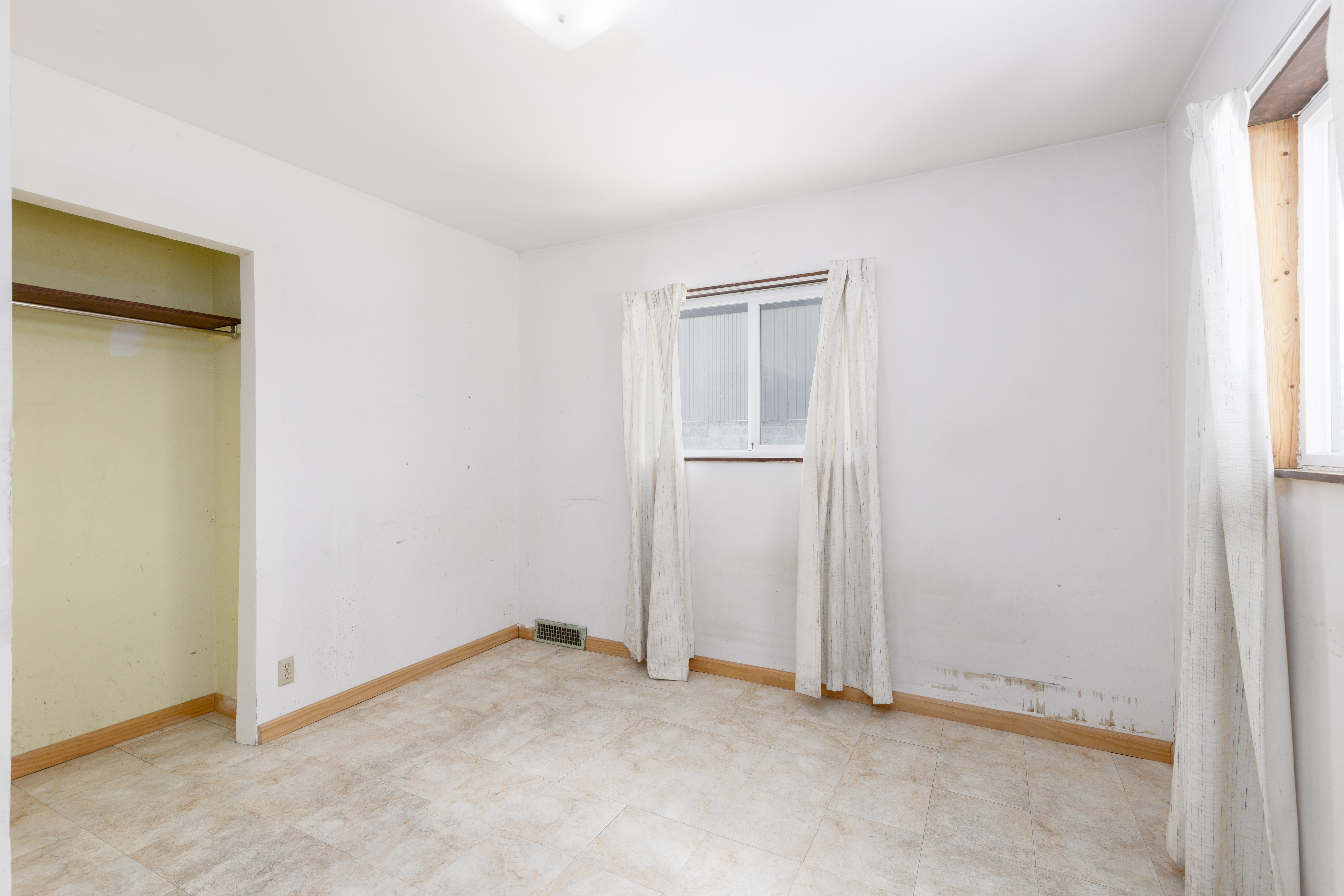 Neutral white walls and light-toned flooring define this room