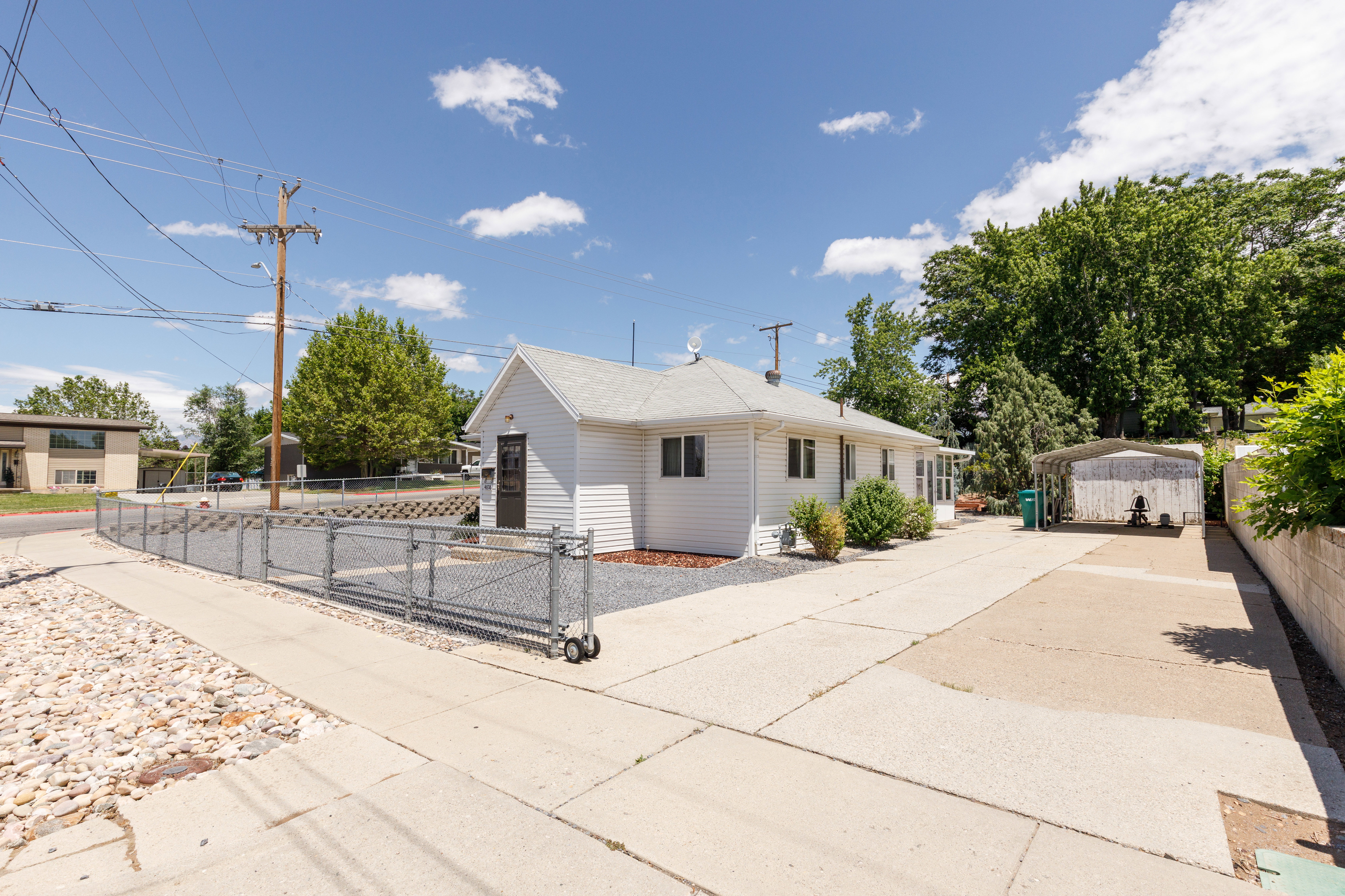 Side exterior with white siding and gray roof
