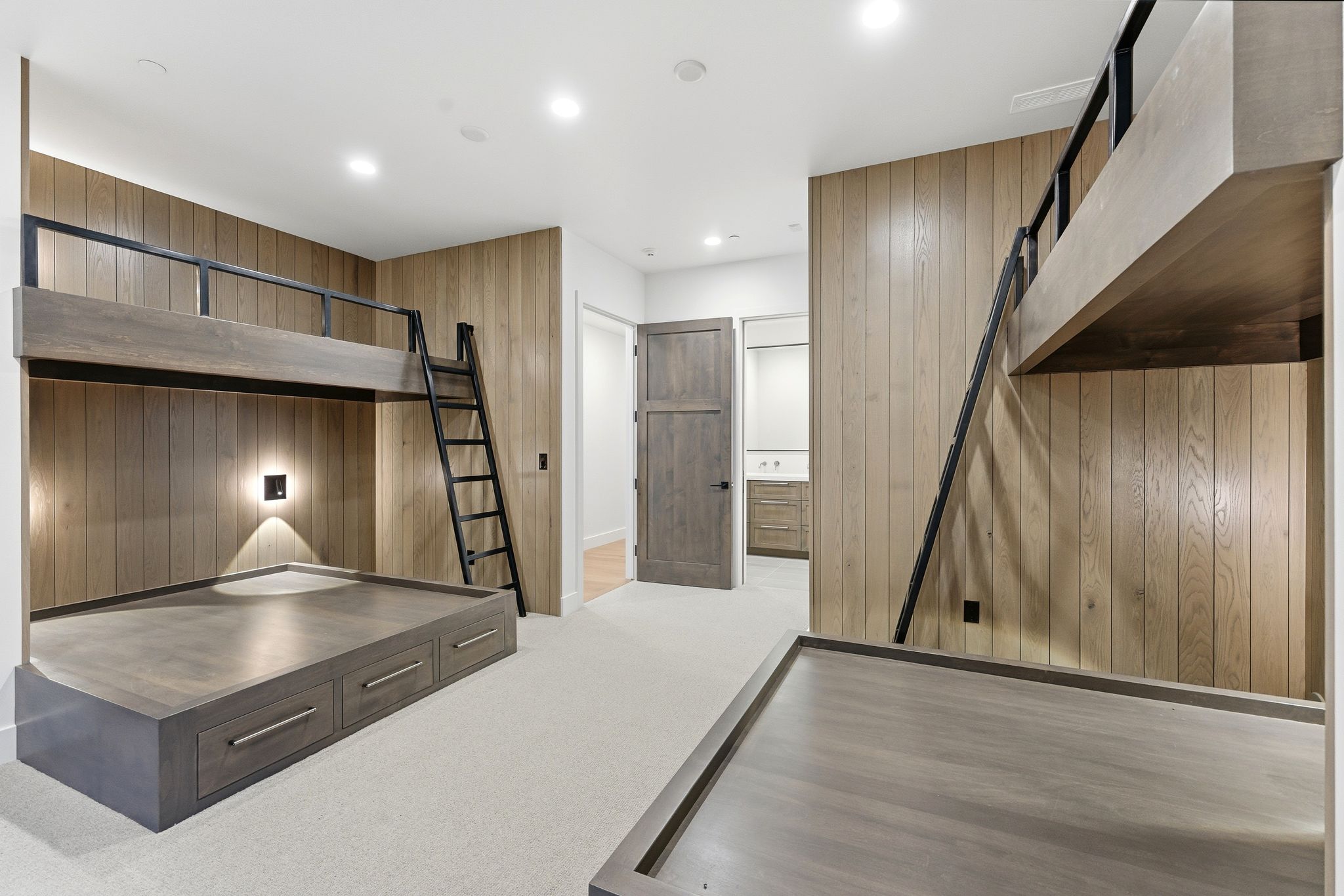 Custom built-in bunk beds with integrated storage drawers and accent lighting