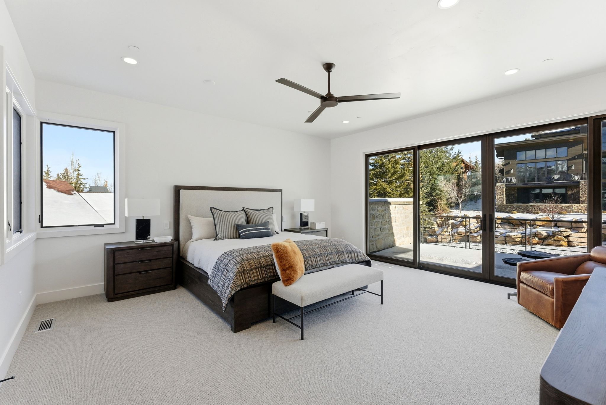 Recessed lighting illuminates this bright room featuring a sliding glass door for outdoor access