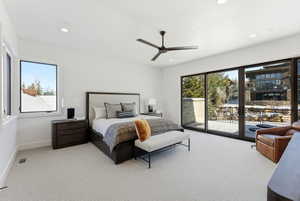 Recessed lighting illuminates this bright room featuring a sliding glass door for outdoor access