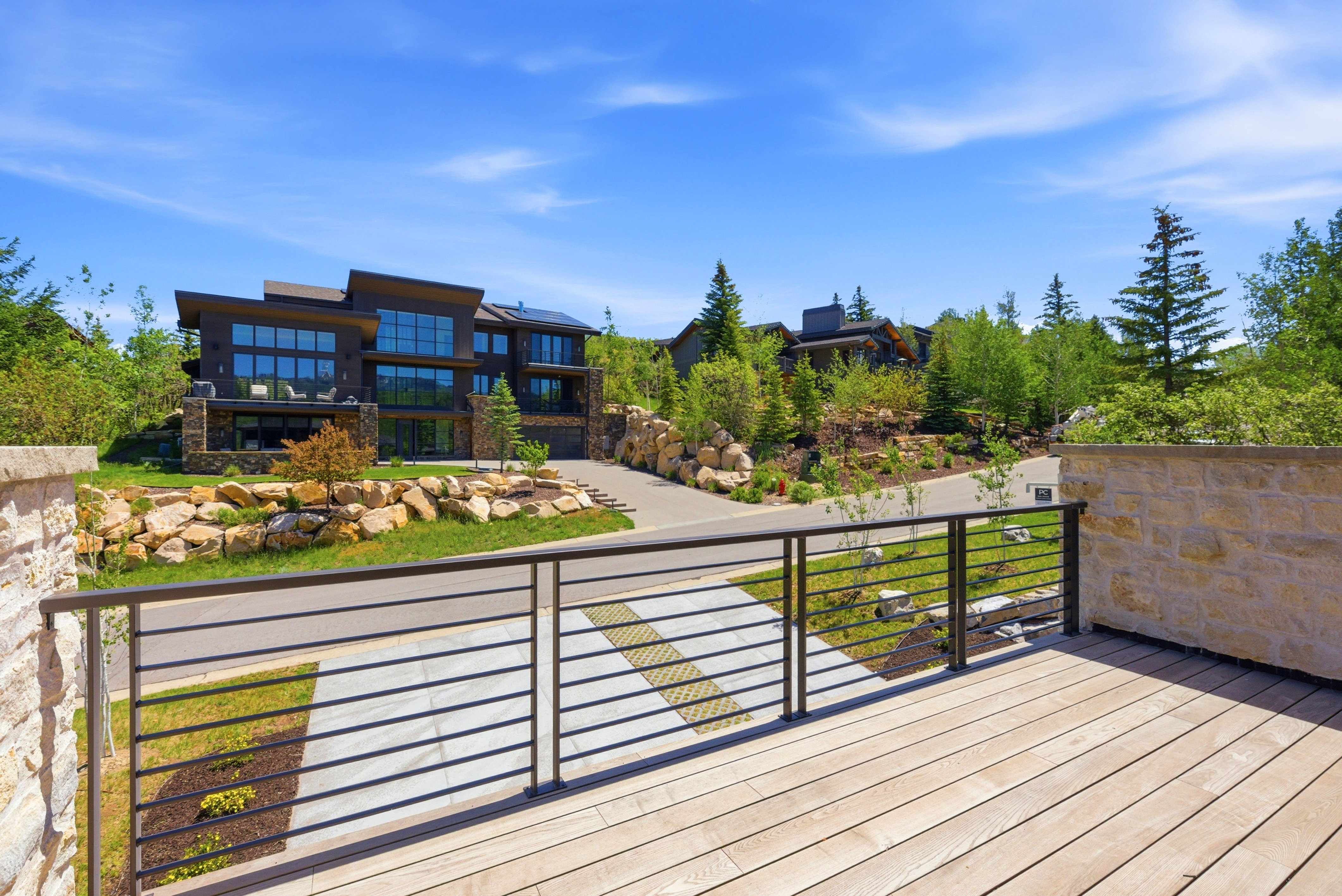 Spacious wood-finish deck with contemporary horizontal bar railing