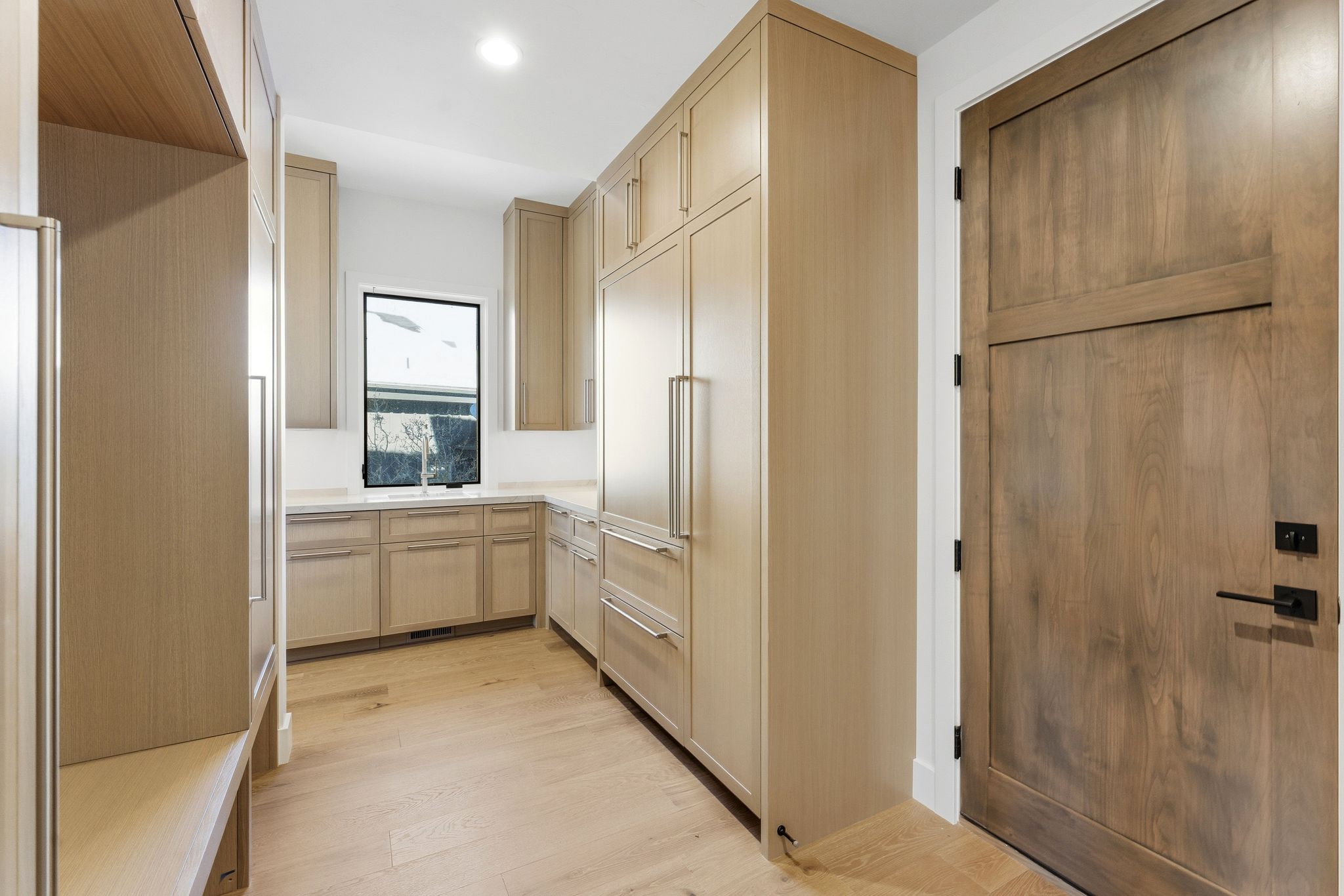 Custom cabinetry and integrated appliances define this space