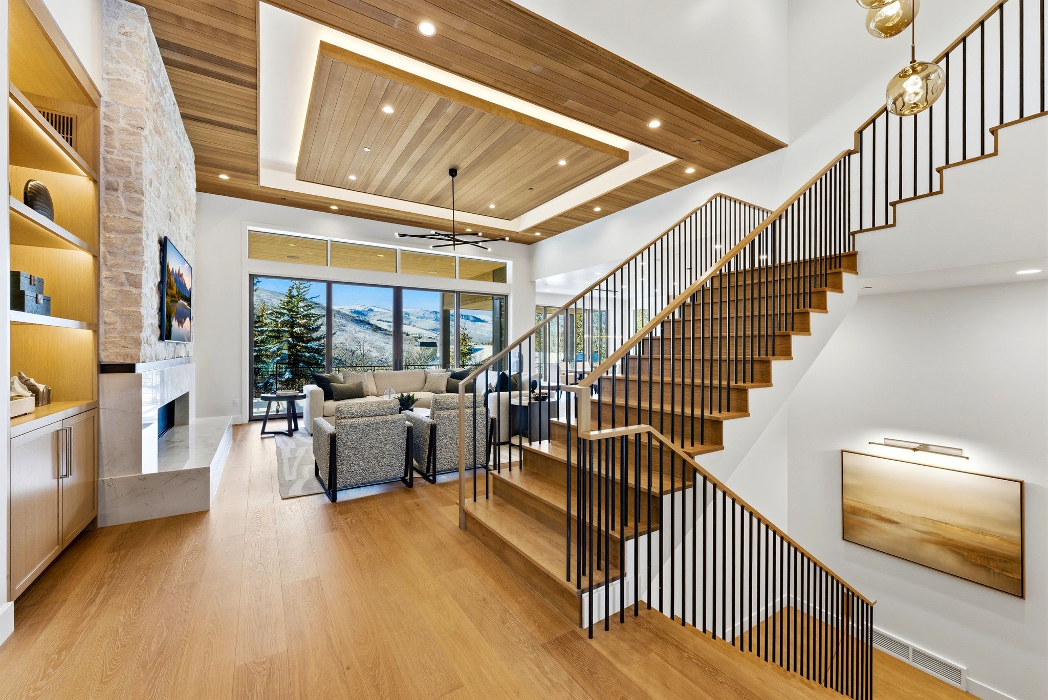 Two-story staircase with wood-finish treads and black metal balusters