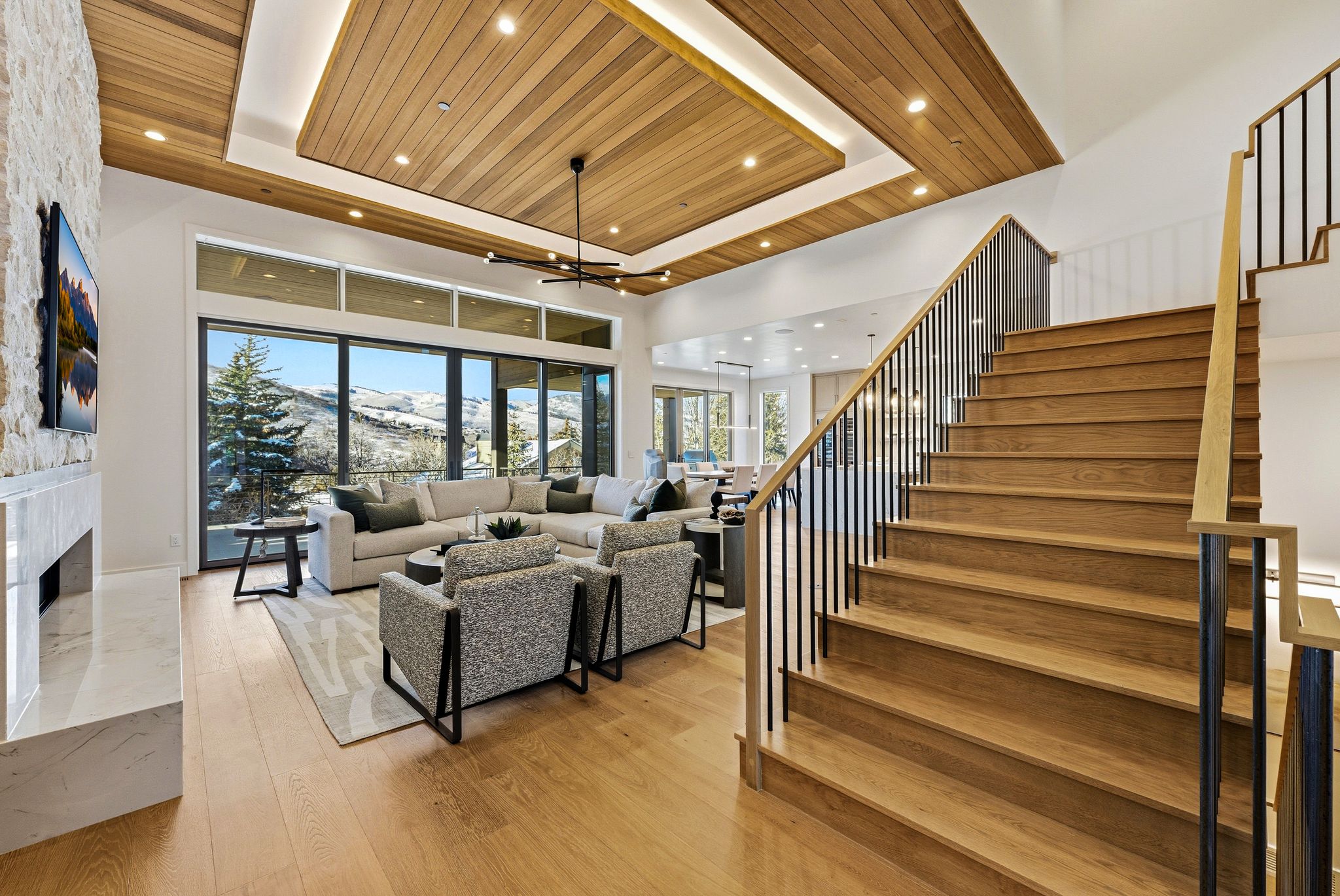 Hardwood staircase with black metal balusters and wood handrails