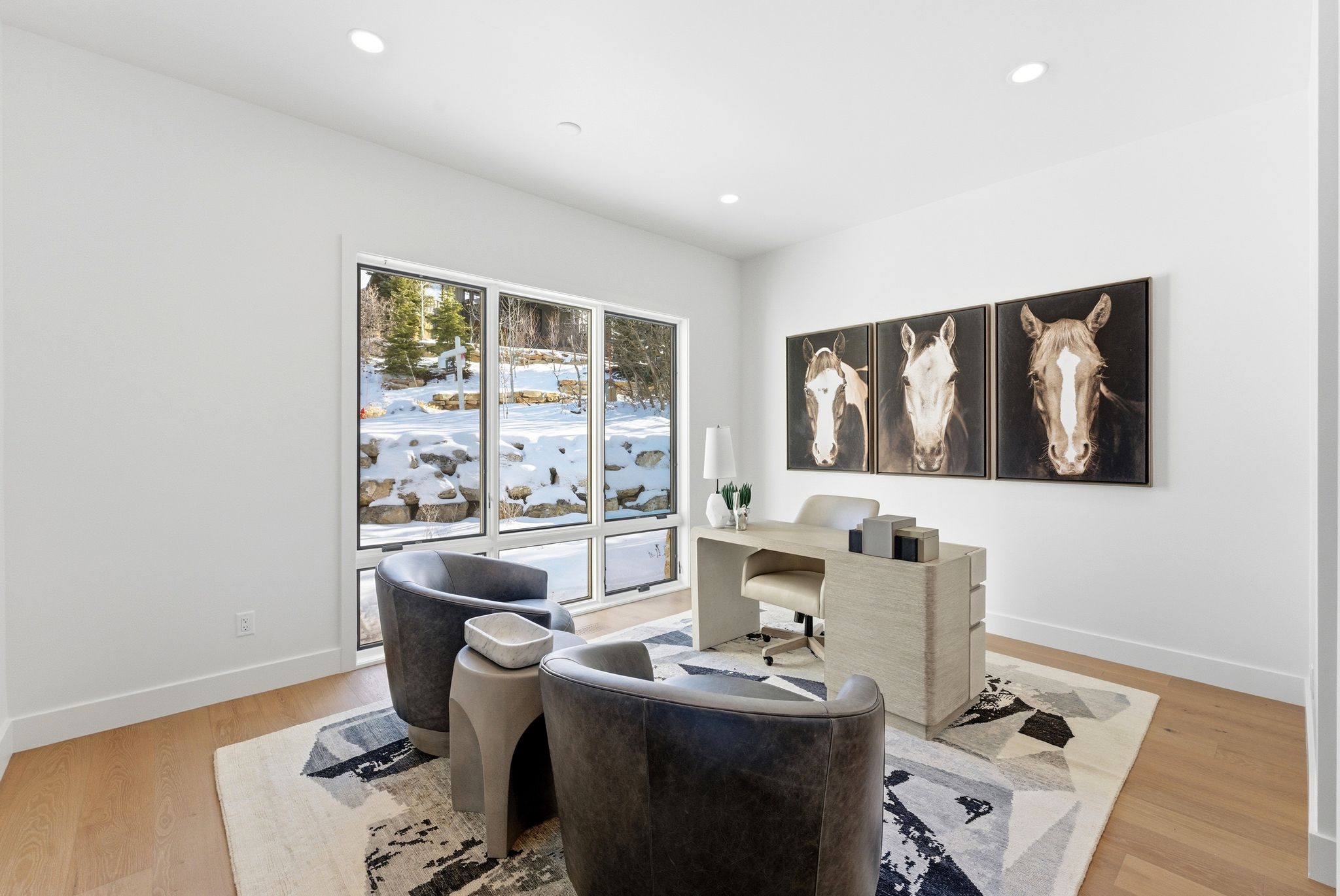Spacious room featuring floor-to-ceiling windows, wood-finish flooring, recessed lighting, and a neutral color palette