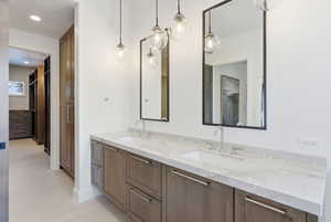 Double vanity with marble-finish countertop, undermount sinks, and brushed nickel fixtures