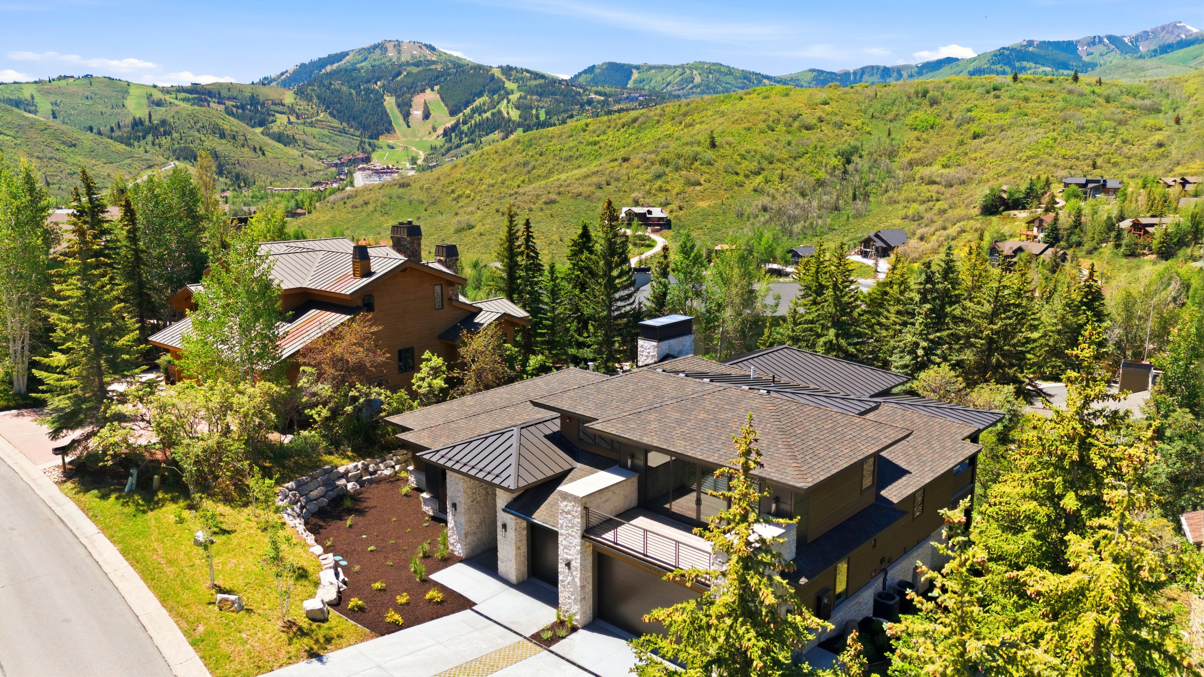 Modern mountain residence featuring a multi-level design and a stone and wood exterior