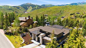 Modern mountain residence featuring a multi-level design and a stone and wood exterior