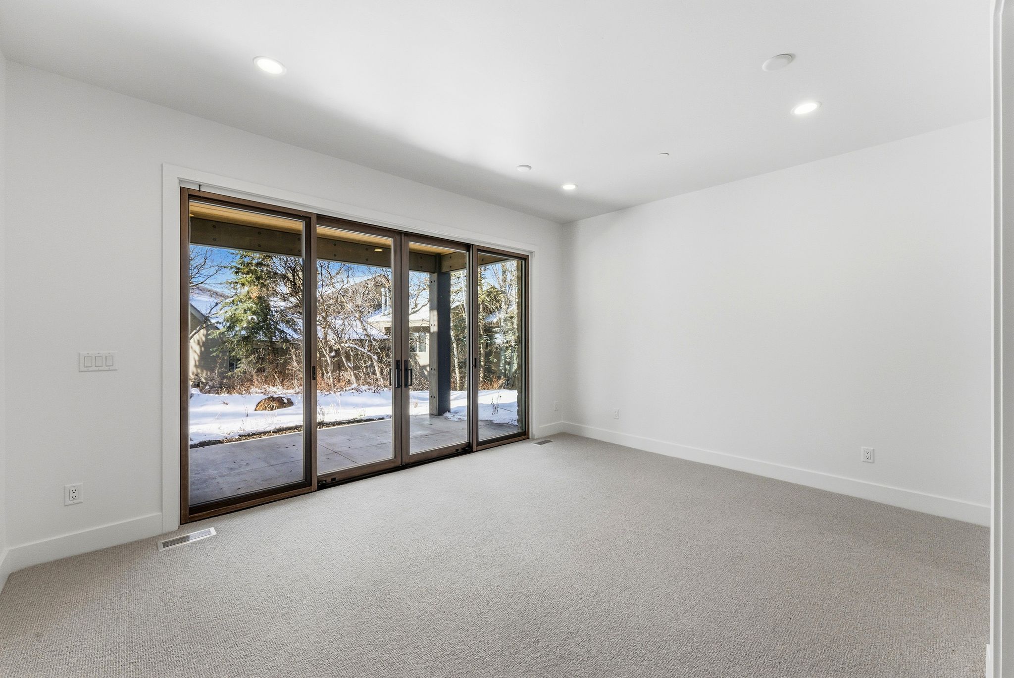 Bright interior space featuring a multi-panel sliding glass door system