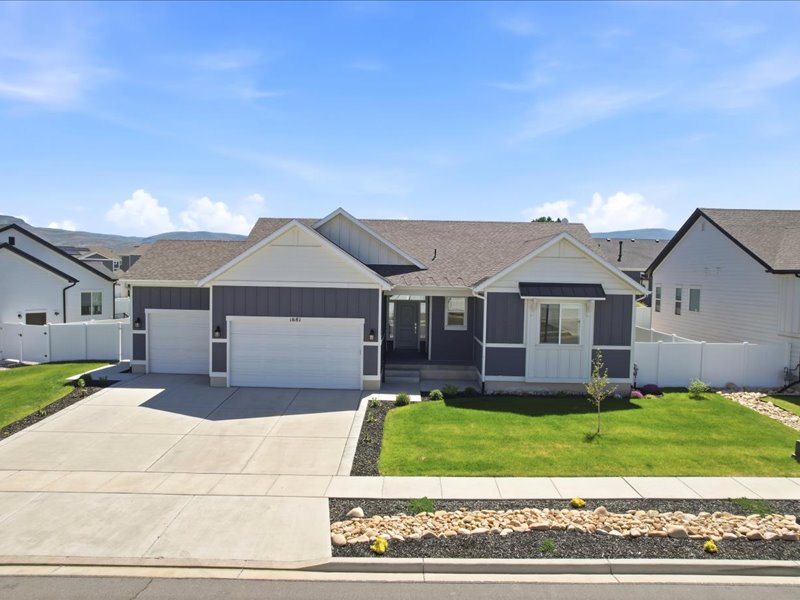 Modern ranch-style home featuring a two-car garage, gray siding, and white trim