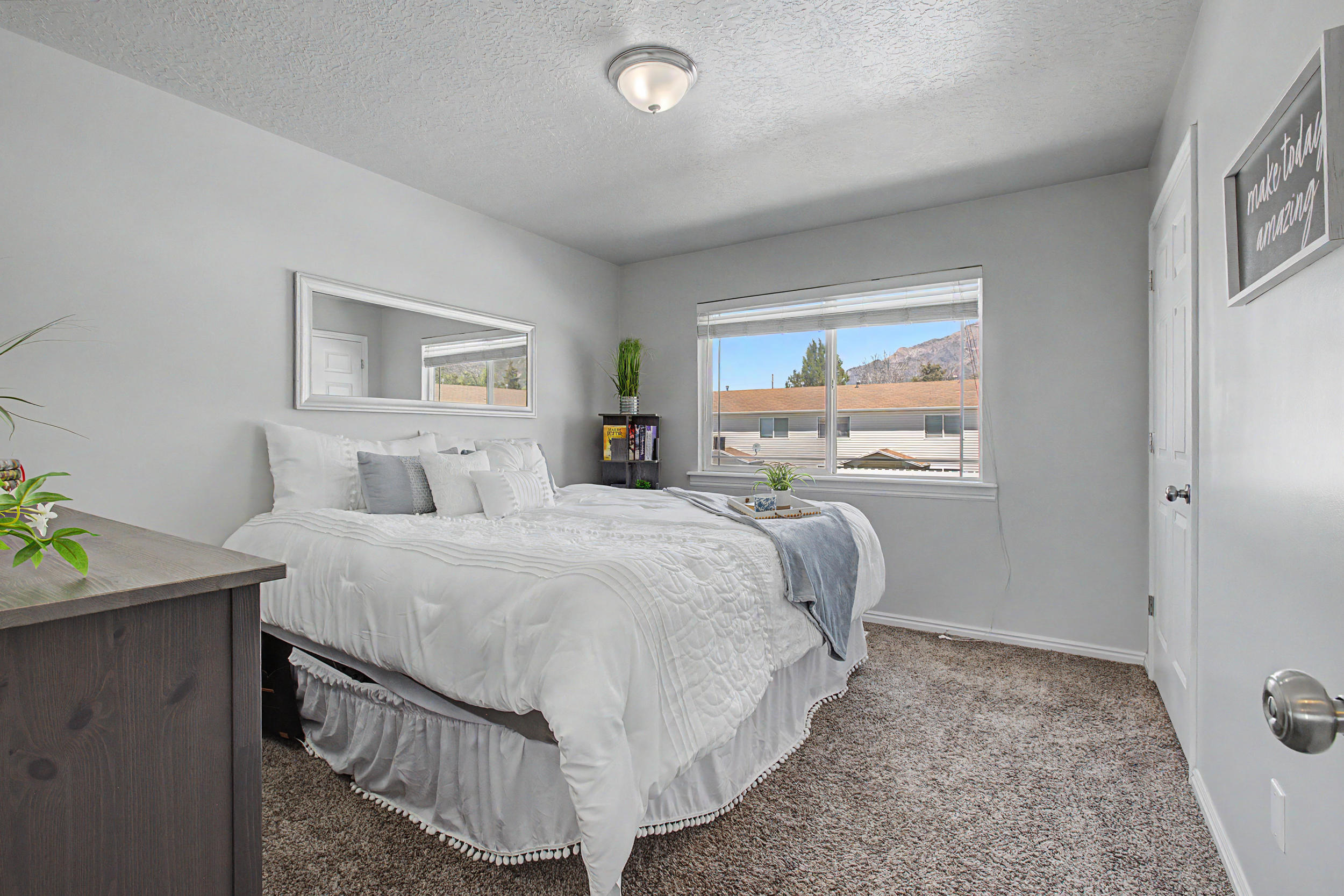 Neutral gray painted walls with white trim and a coordinating neutral carpet