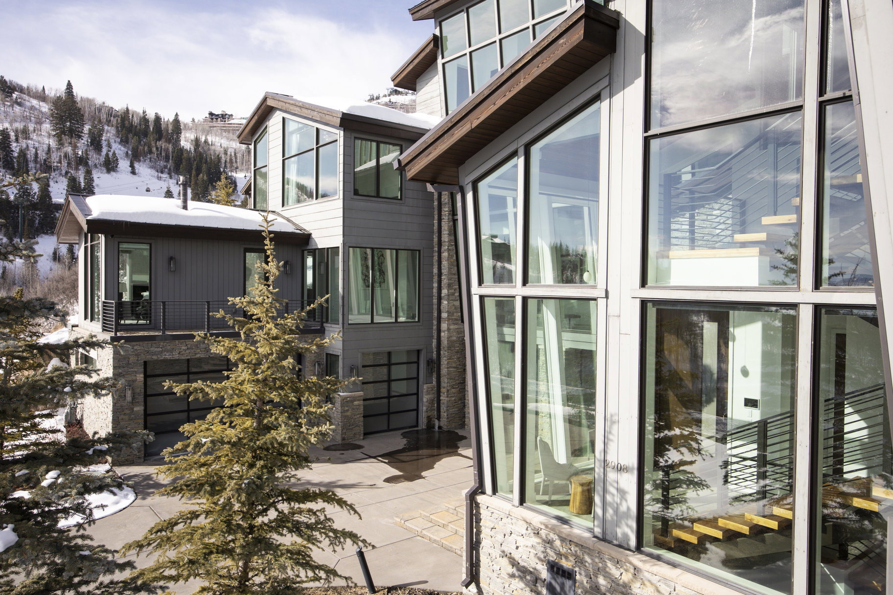 Modern architectural exterior featuring extensive window arrays and stone detailing