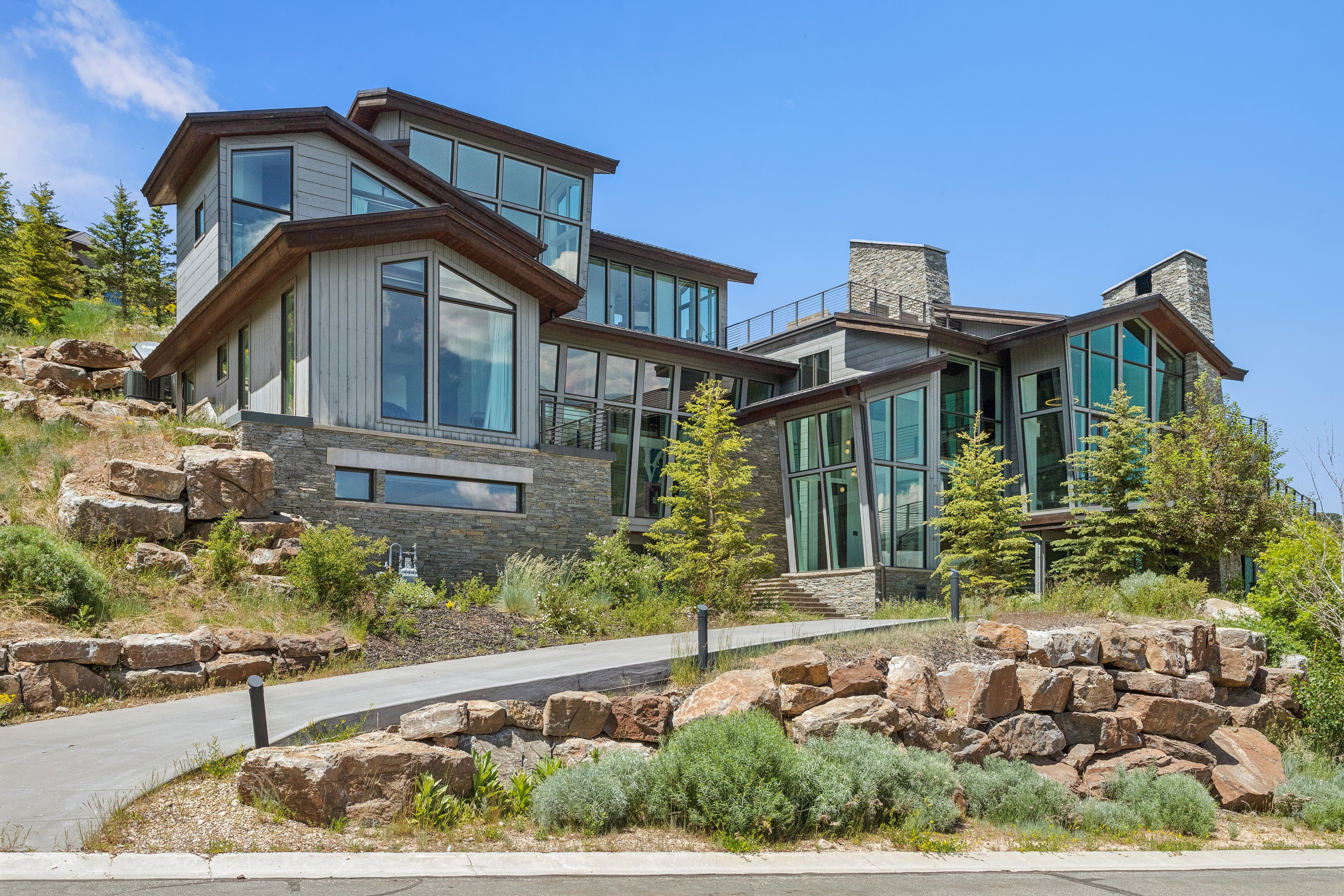 Contemporary exterior with extensive glazing and stone accents