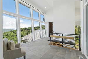 Expansive window wall with mountain and forested landscape