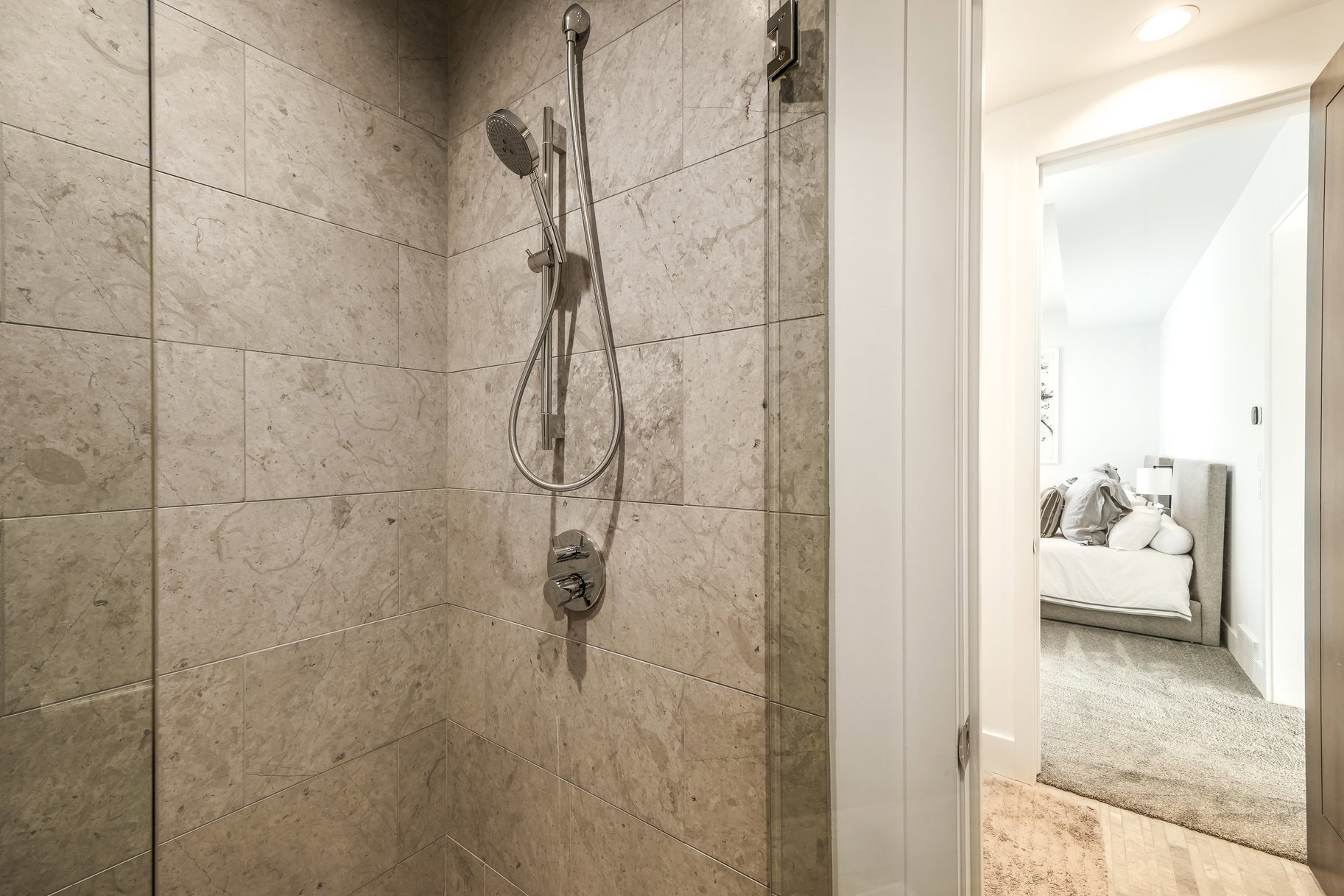 Shower enclosure with large format stone-finish wall tiling