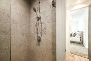 Shower enclosure with large format stone-finish wall tiling