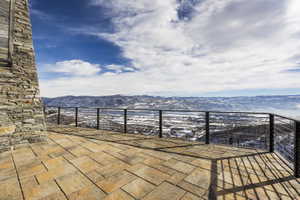 Expansive outdoor patio featuring flagstone paving and a stone-clad exterior wall