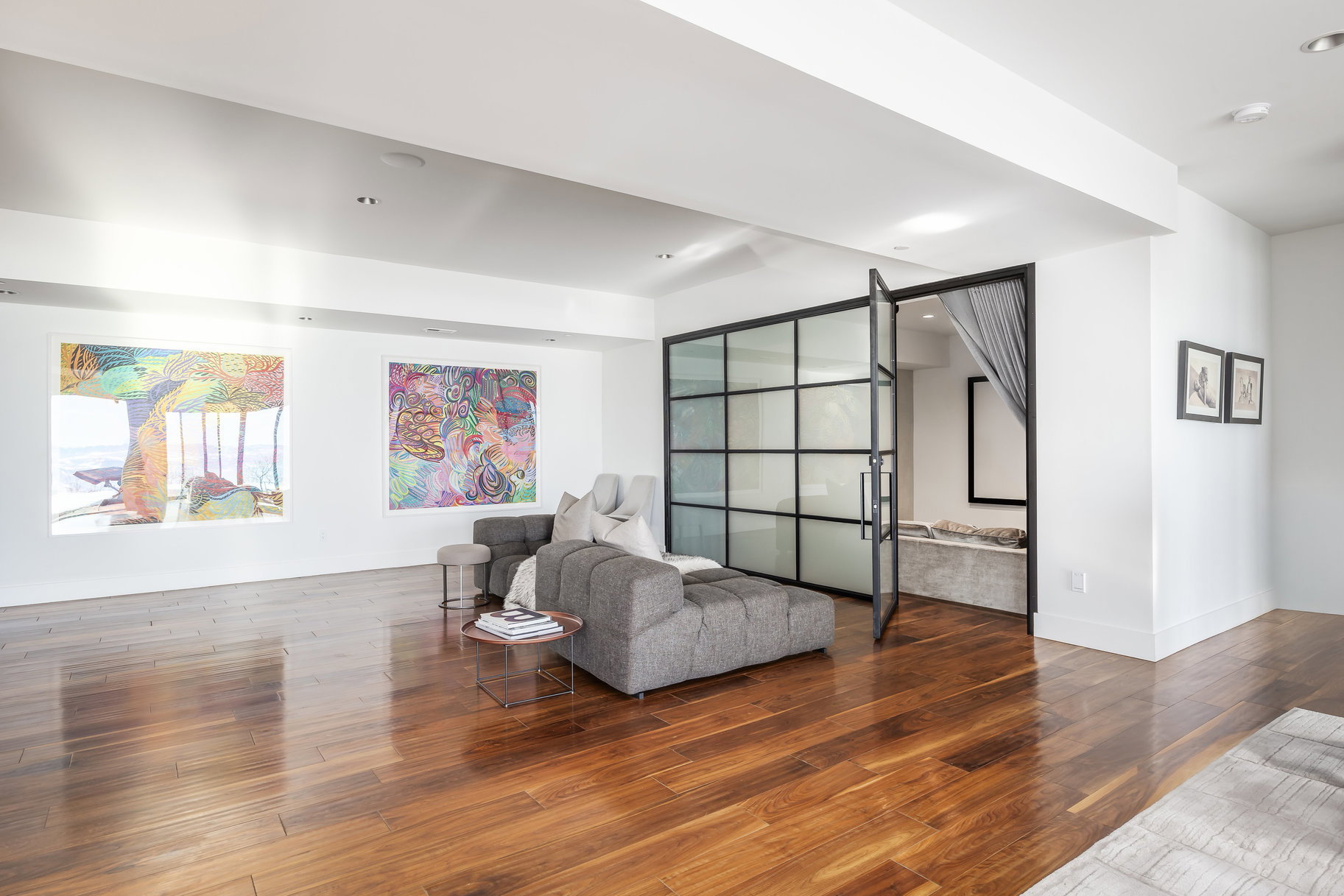 Expansive interior space featuring wide plank wood-finish flooring