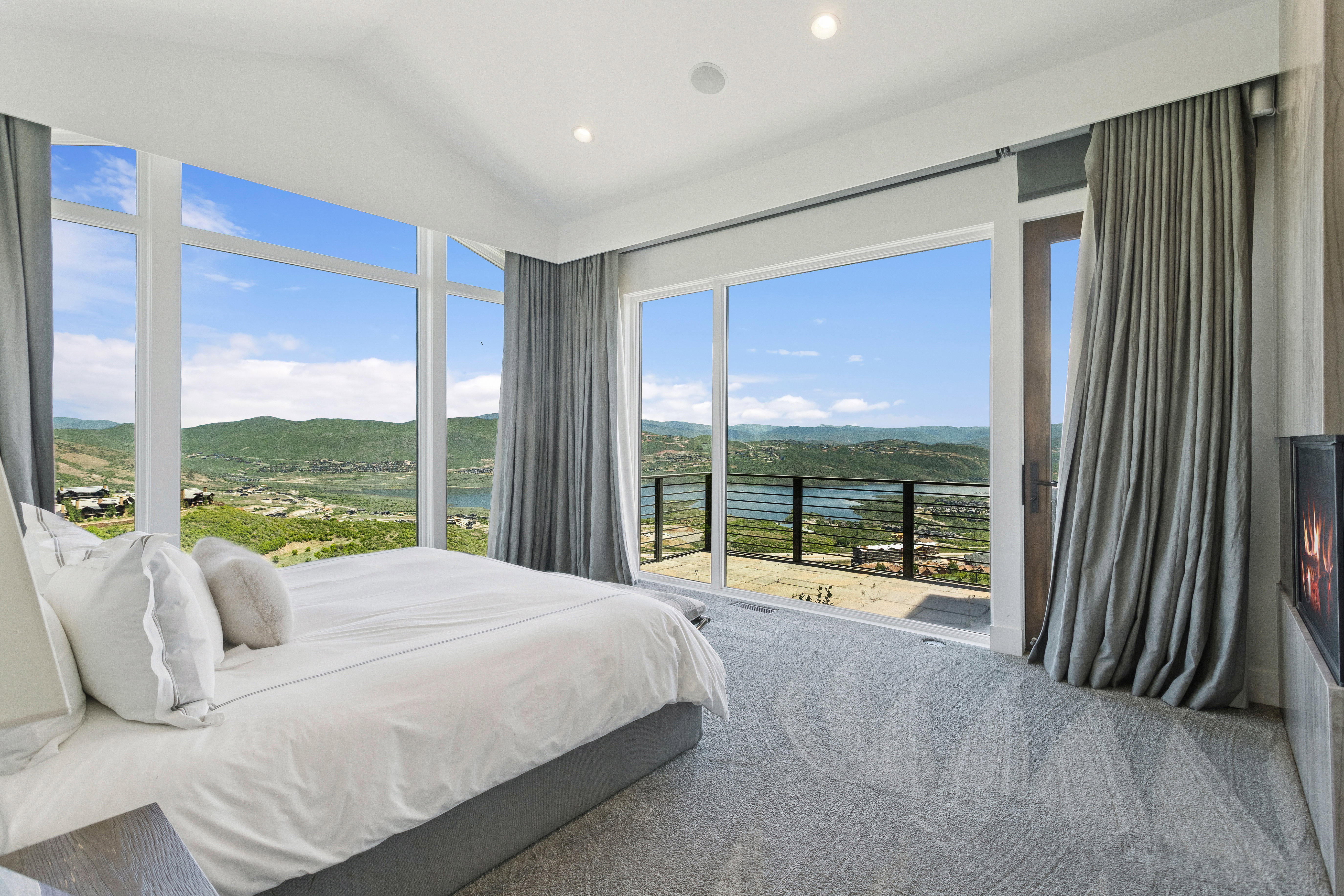 Floor-to-ceiling windows with expansive mountain and lake scenery